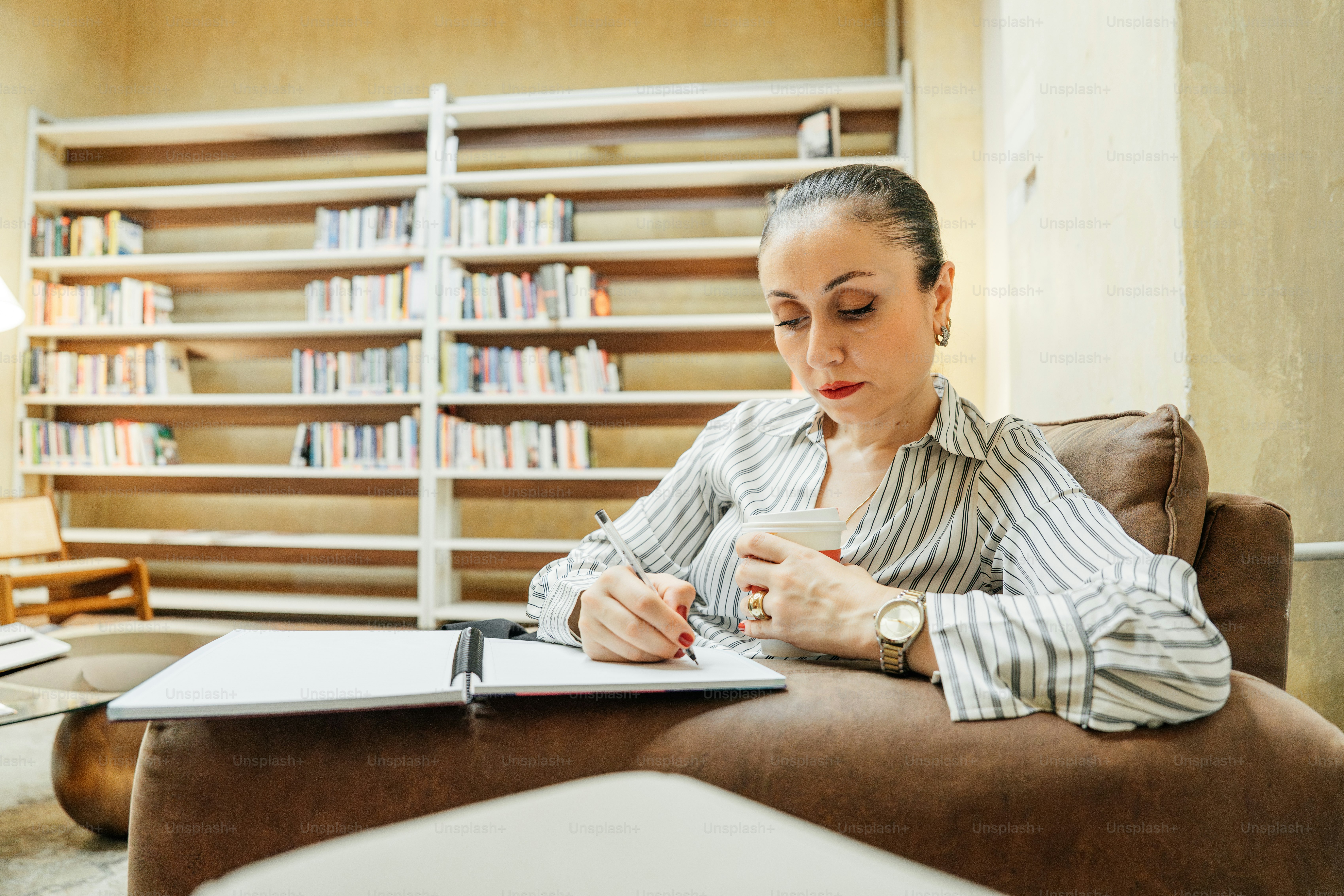 Researcher reviewing notes beside a laptop and notebook
