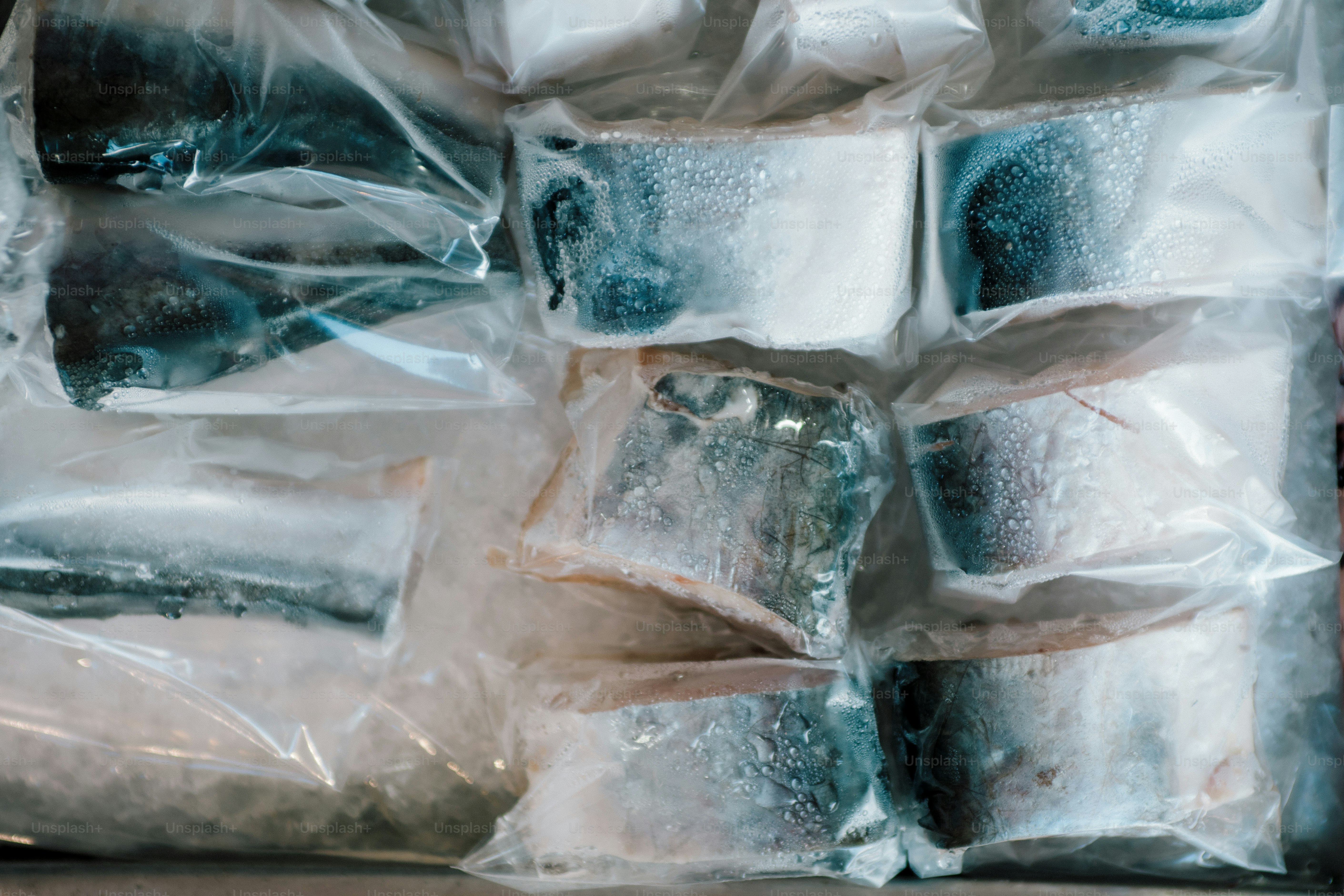 Frozen fish portions packed in plastic wrap photo – Seafood Image on ...