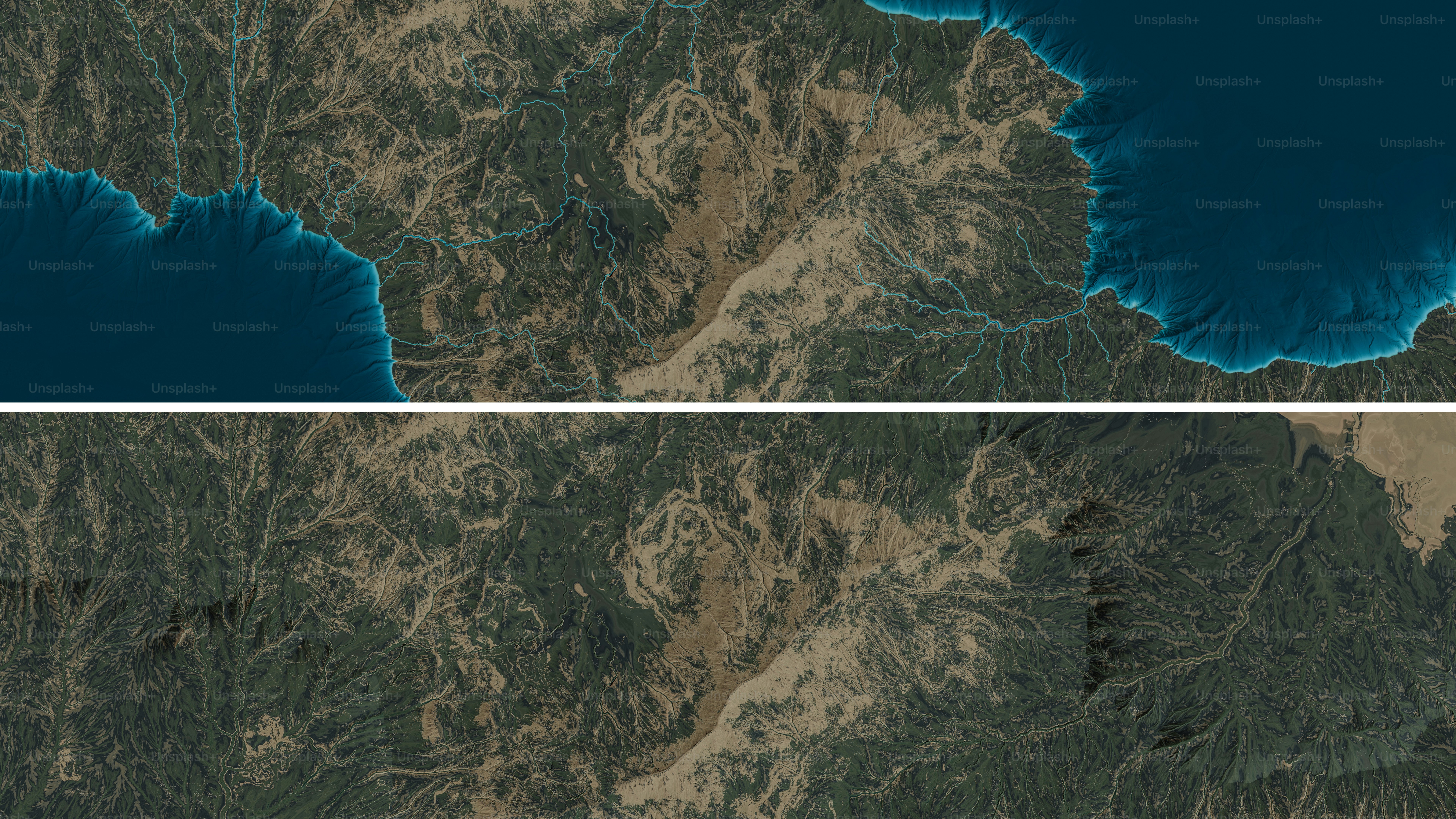 Aerial view of coastal mountains and blue ocean.