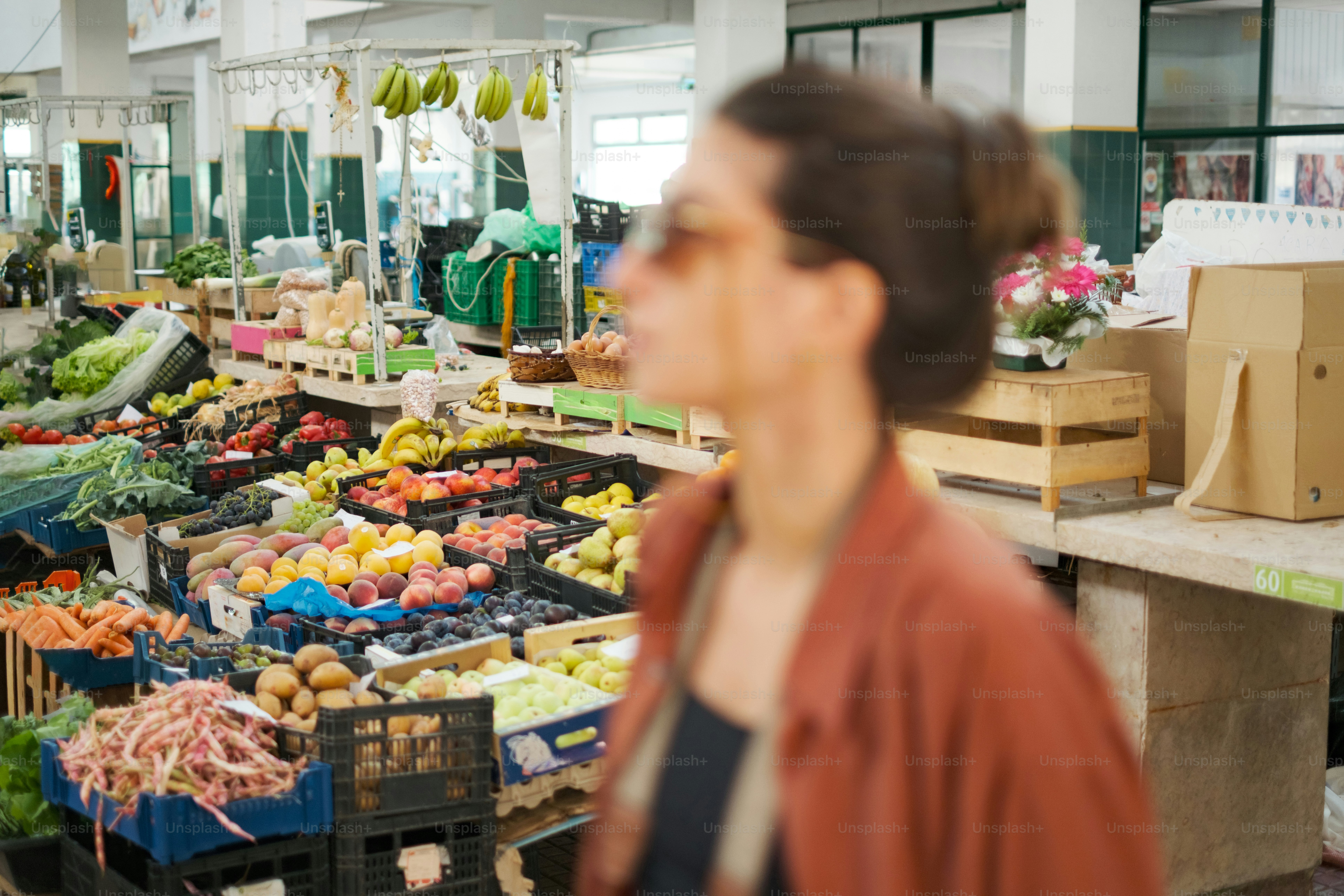 Woman browsing fresh produce at an indoor market