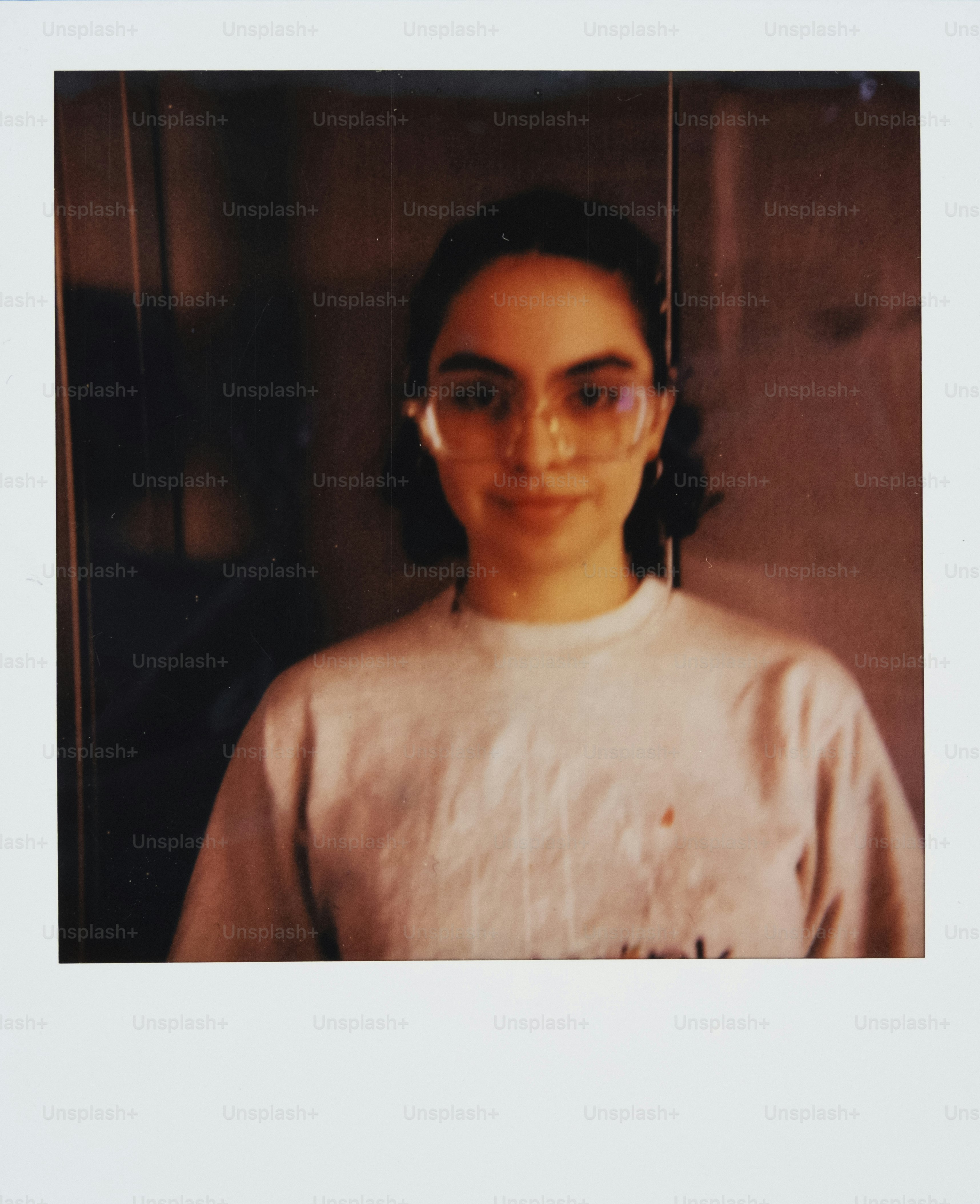 Young woman with glasses wearing a t-shirt.