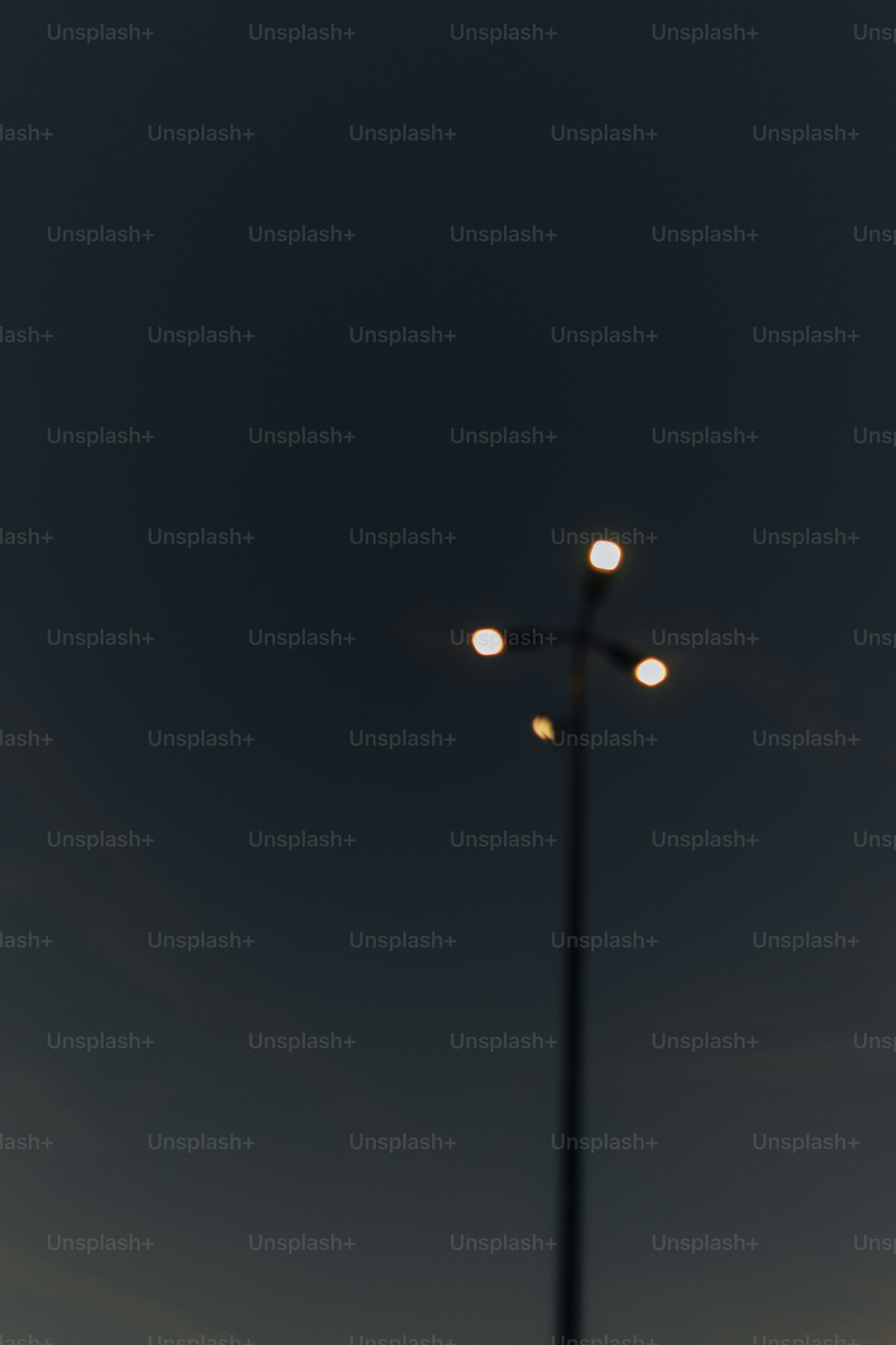 Streetlight glowing against a dark sky