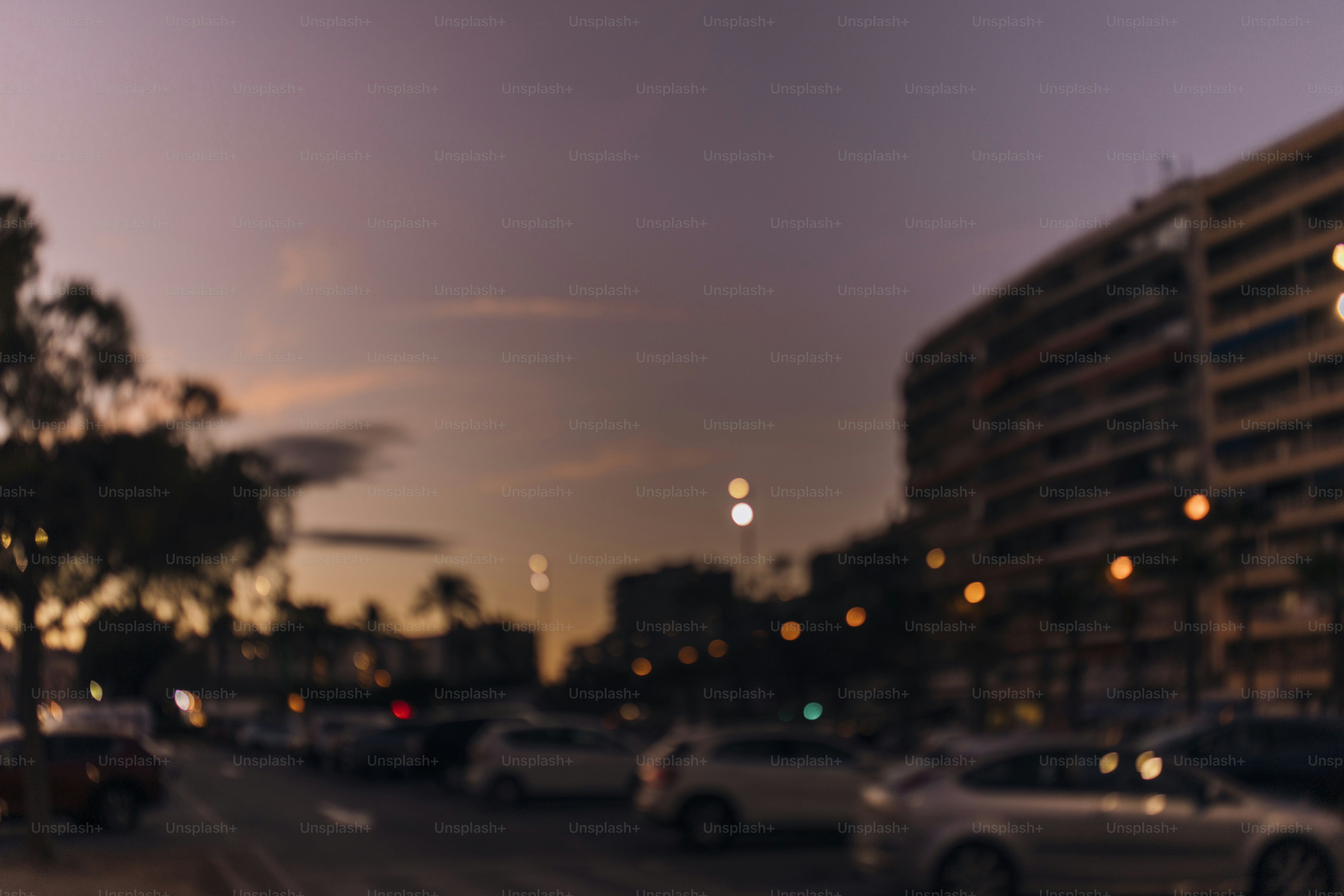 Blurred cityscape with cars and buildings at dusk. photo – Car Image on ...