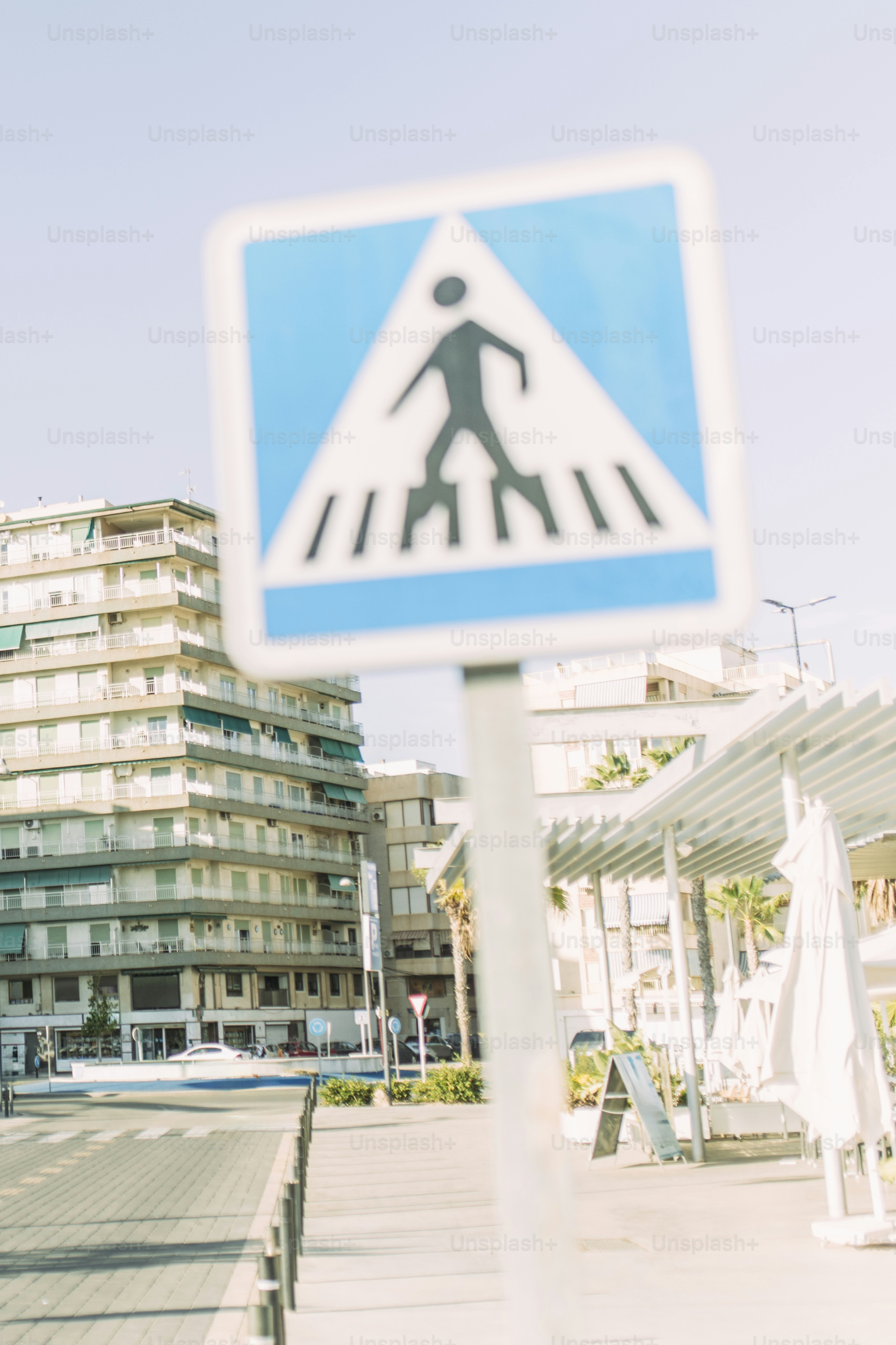 Pedestrian crossing sign with buildings in background