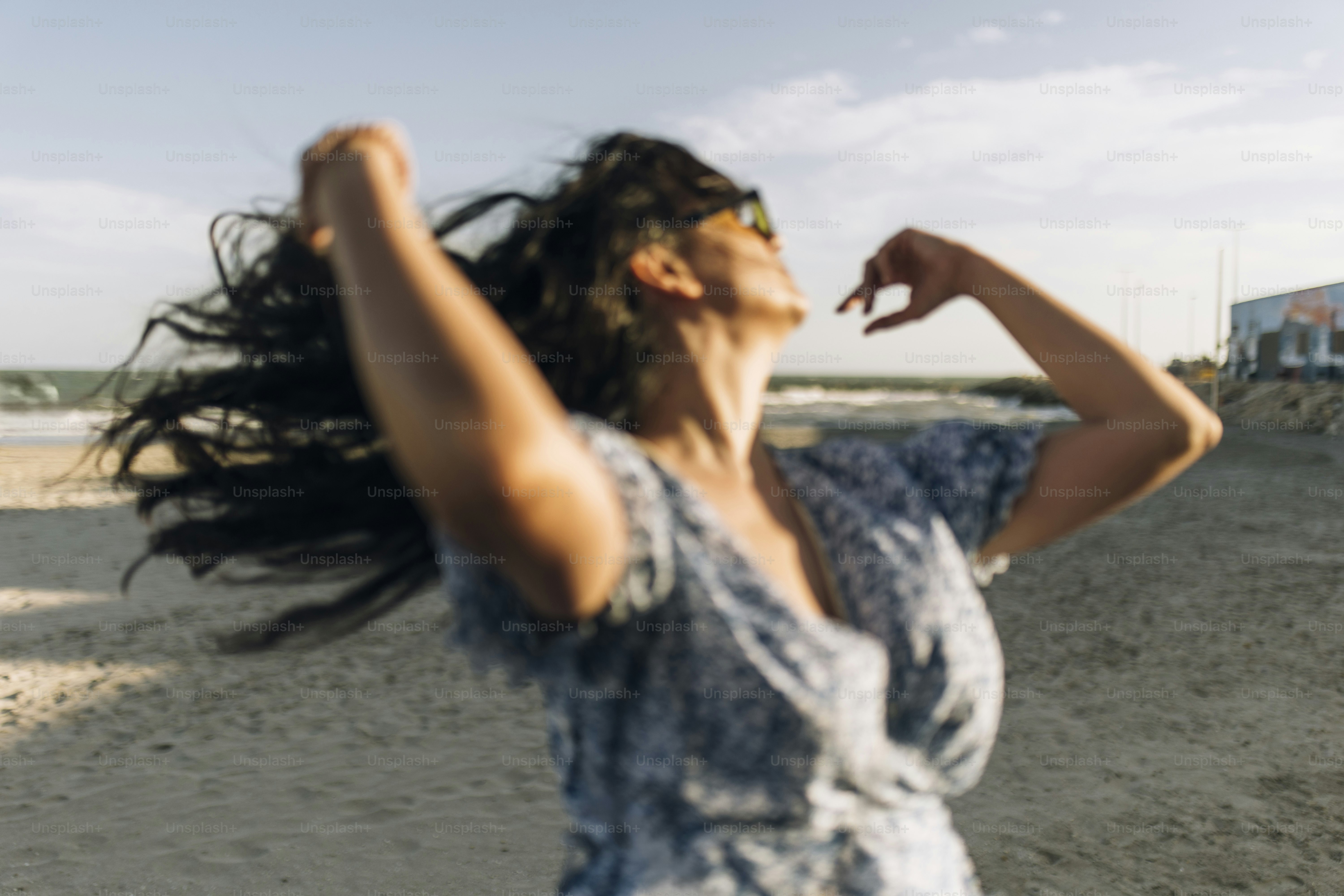 Woman with long dark hair on a beach
