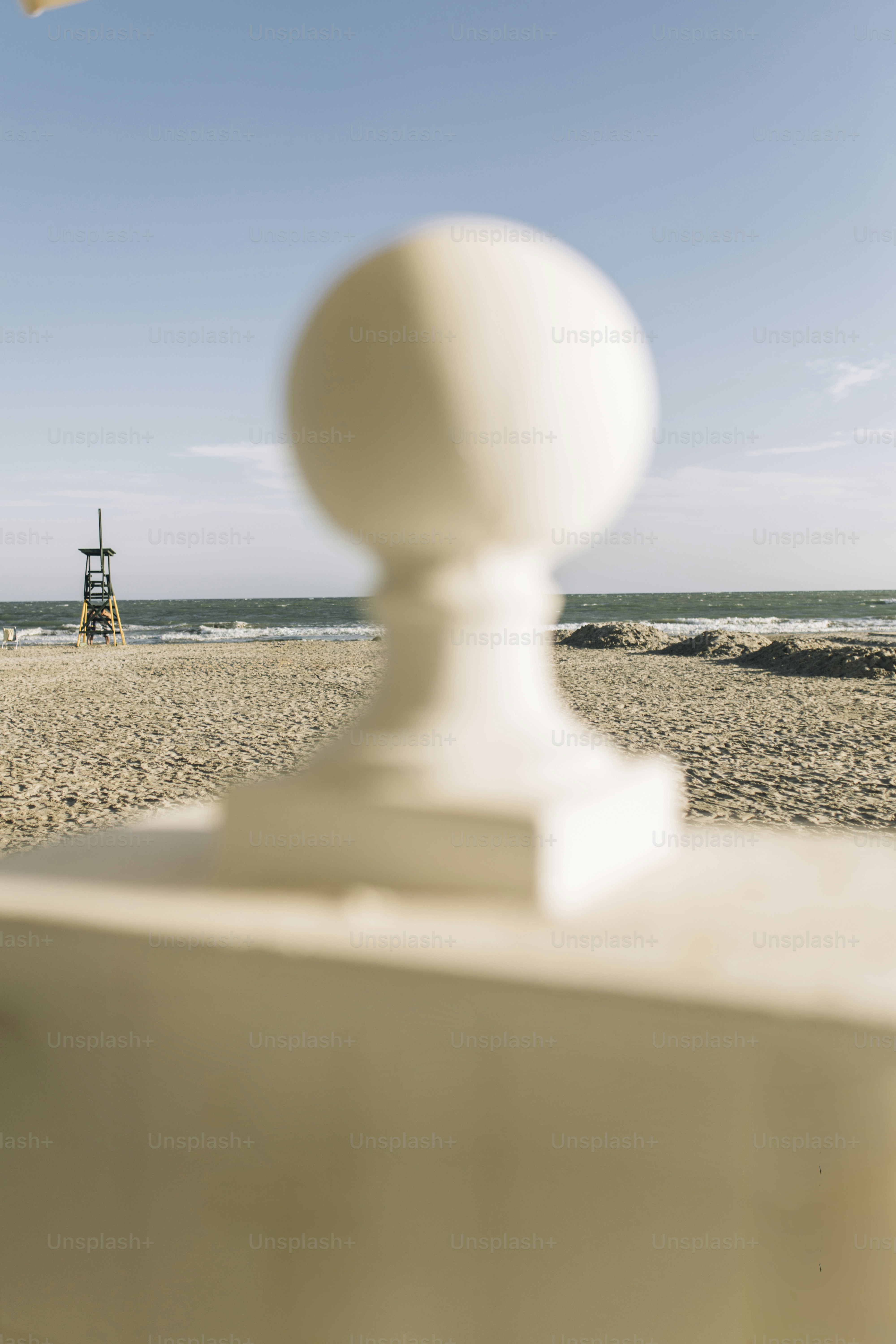 Beach with lifeguard tower and ocean in background
