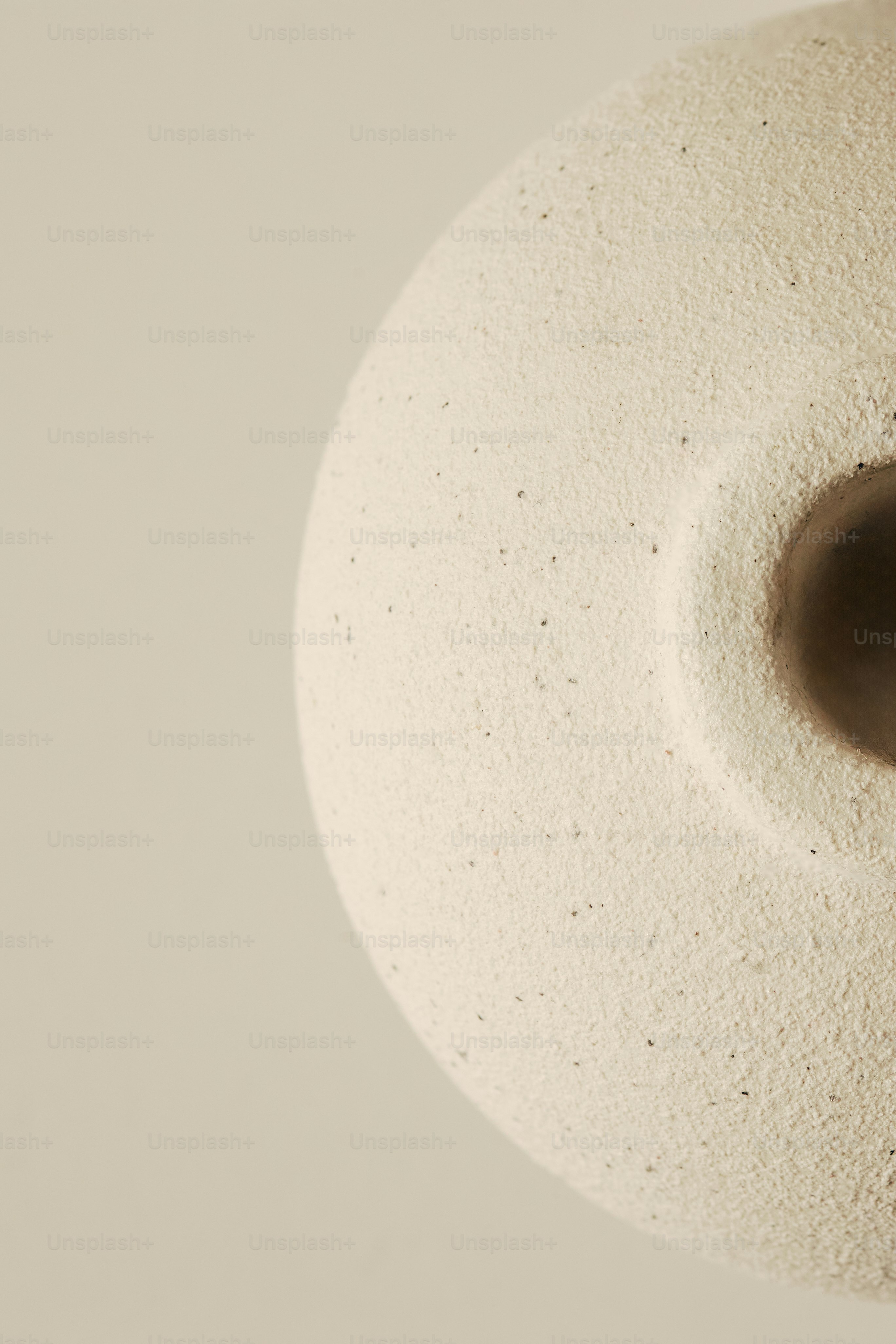 Textured ceramic vase with a dark opening