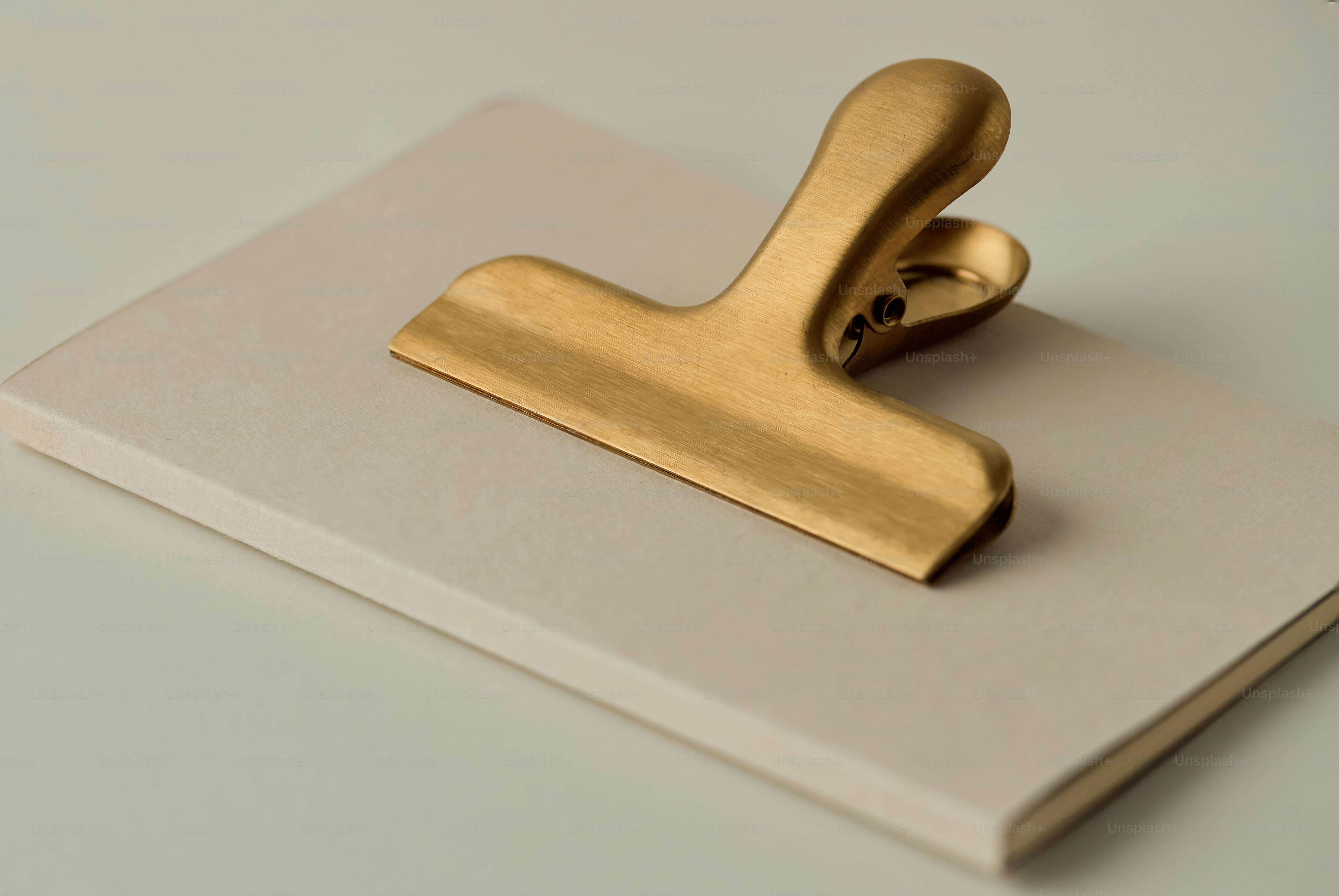 Golden clip on a light-colored notebook
