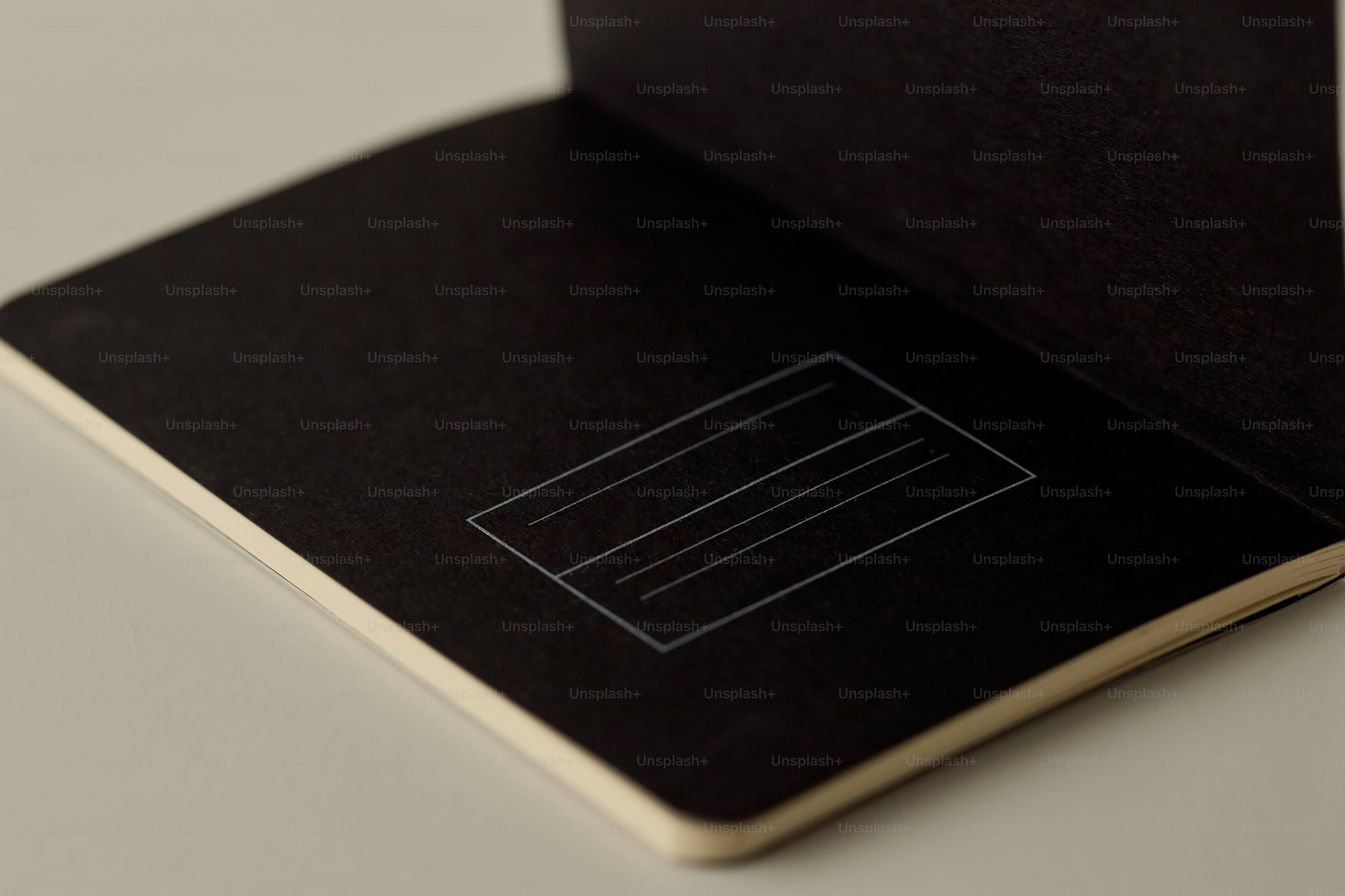 Open black notebook with blank label