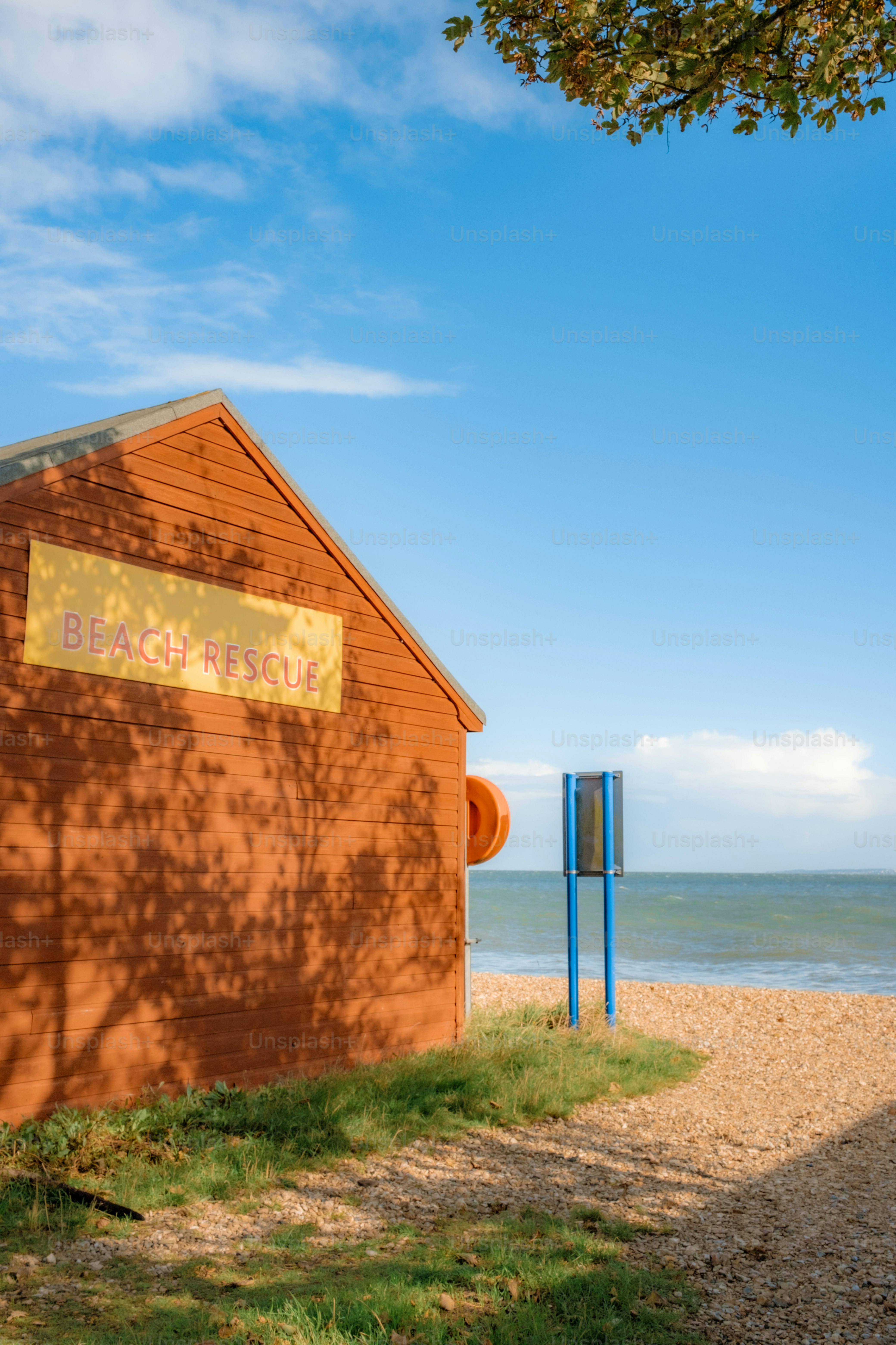 Beach rescue hut with ocean and sky background.