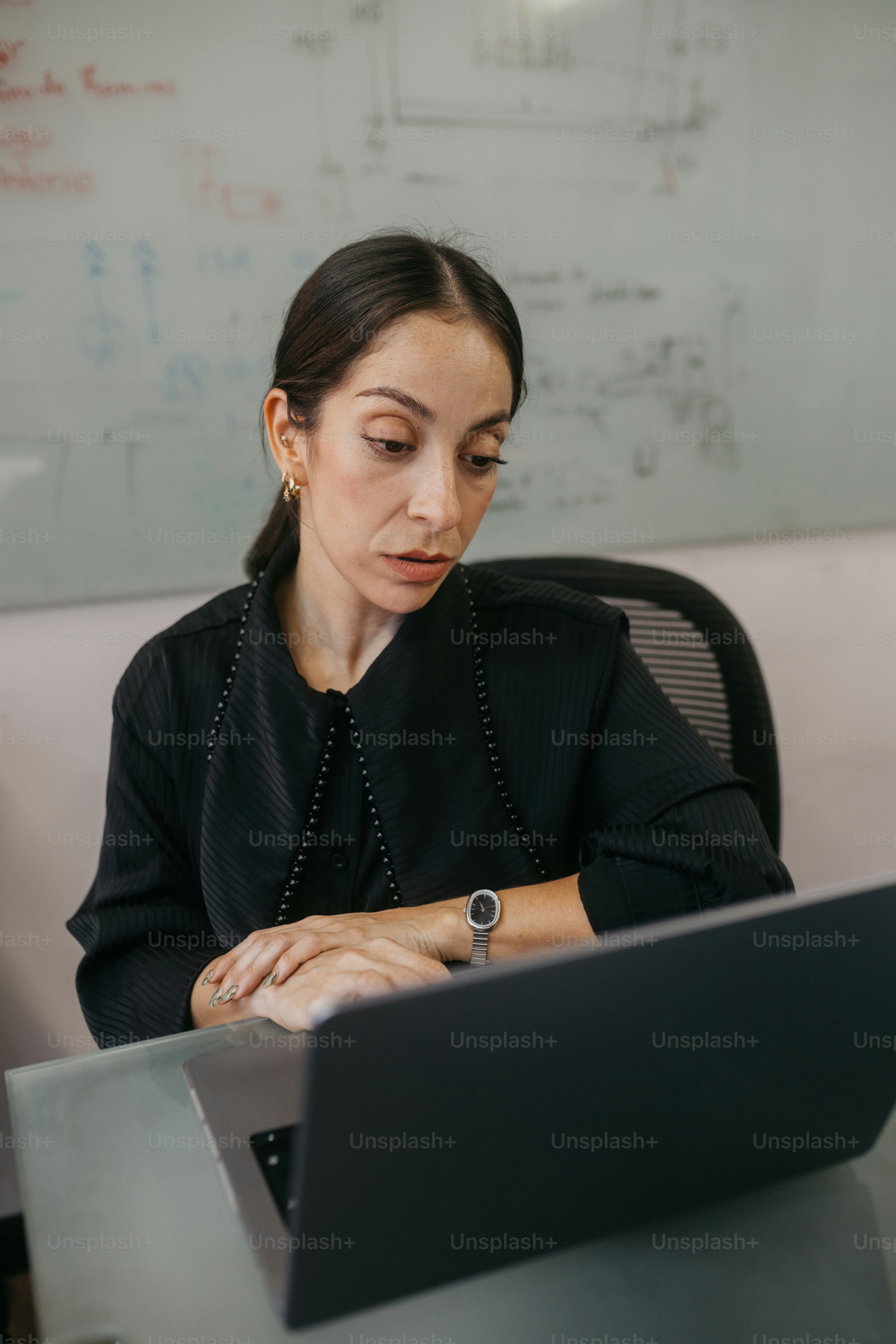 Woman looking at a laptop in an office