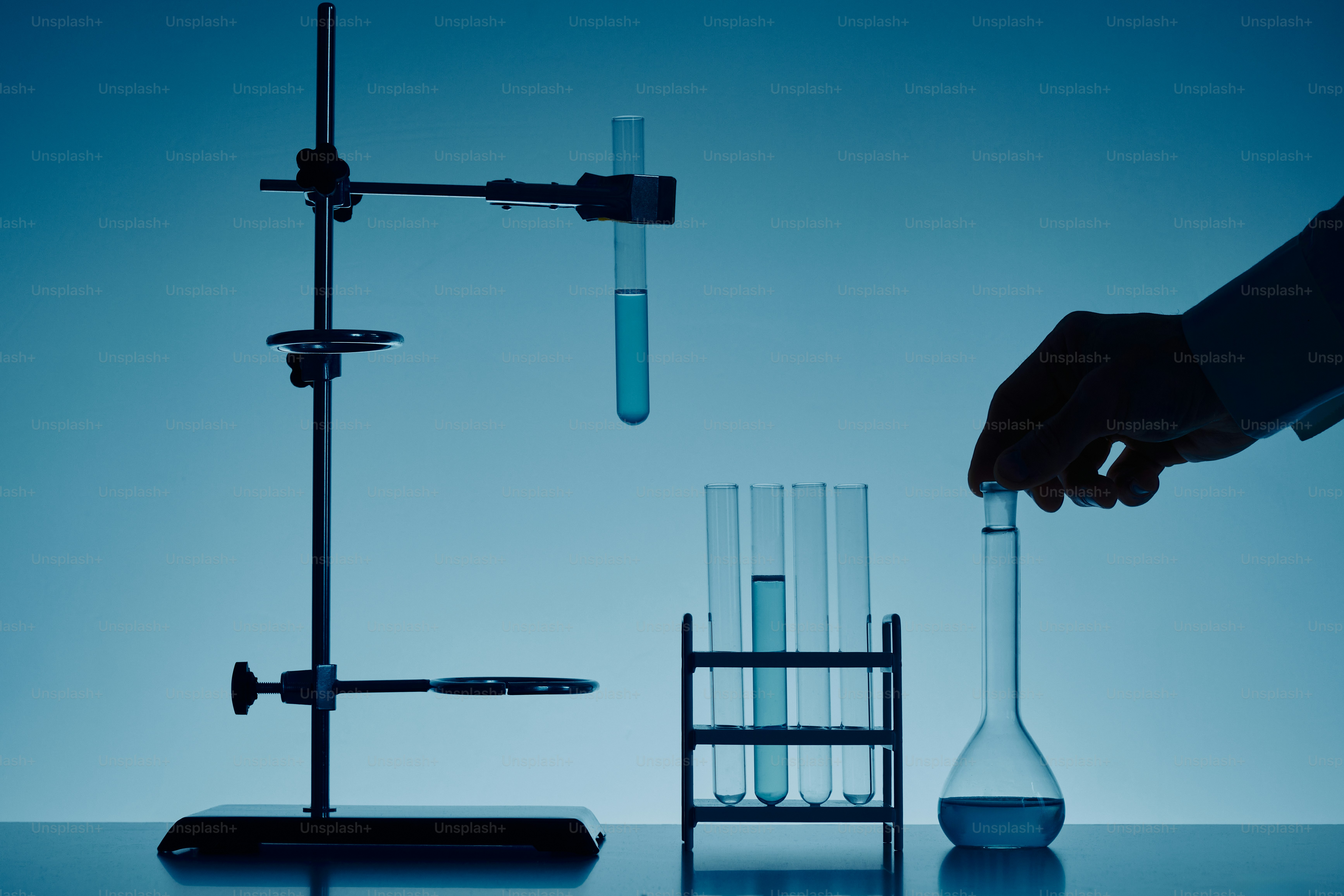 Scientist conducts experiment with test tubes and flask photo – Science ...