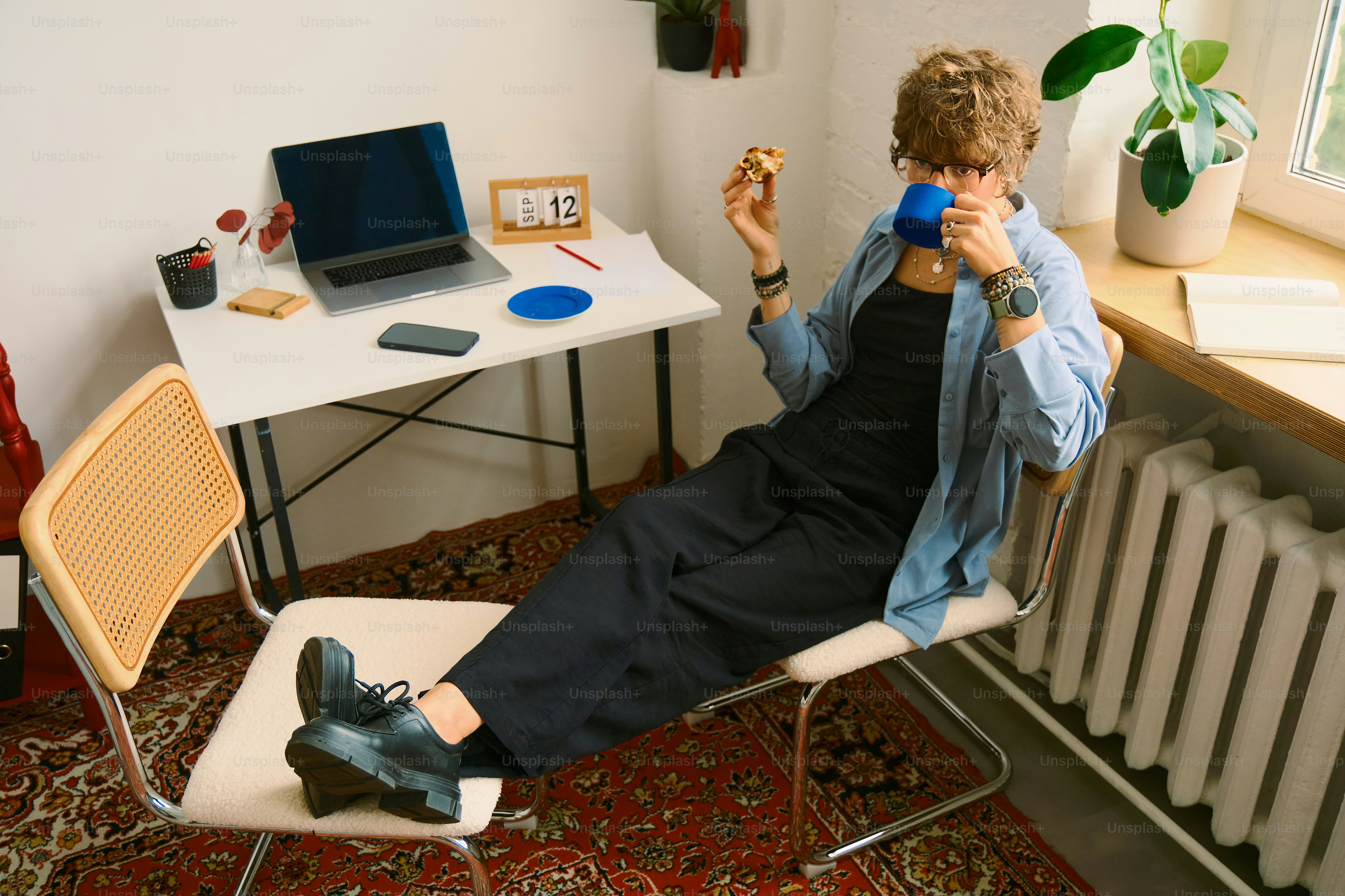 Mulher bebendo café e comendo biscoito na mesa
