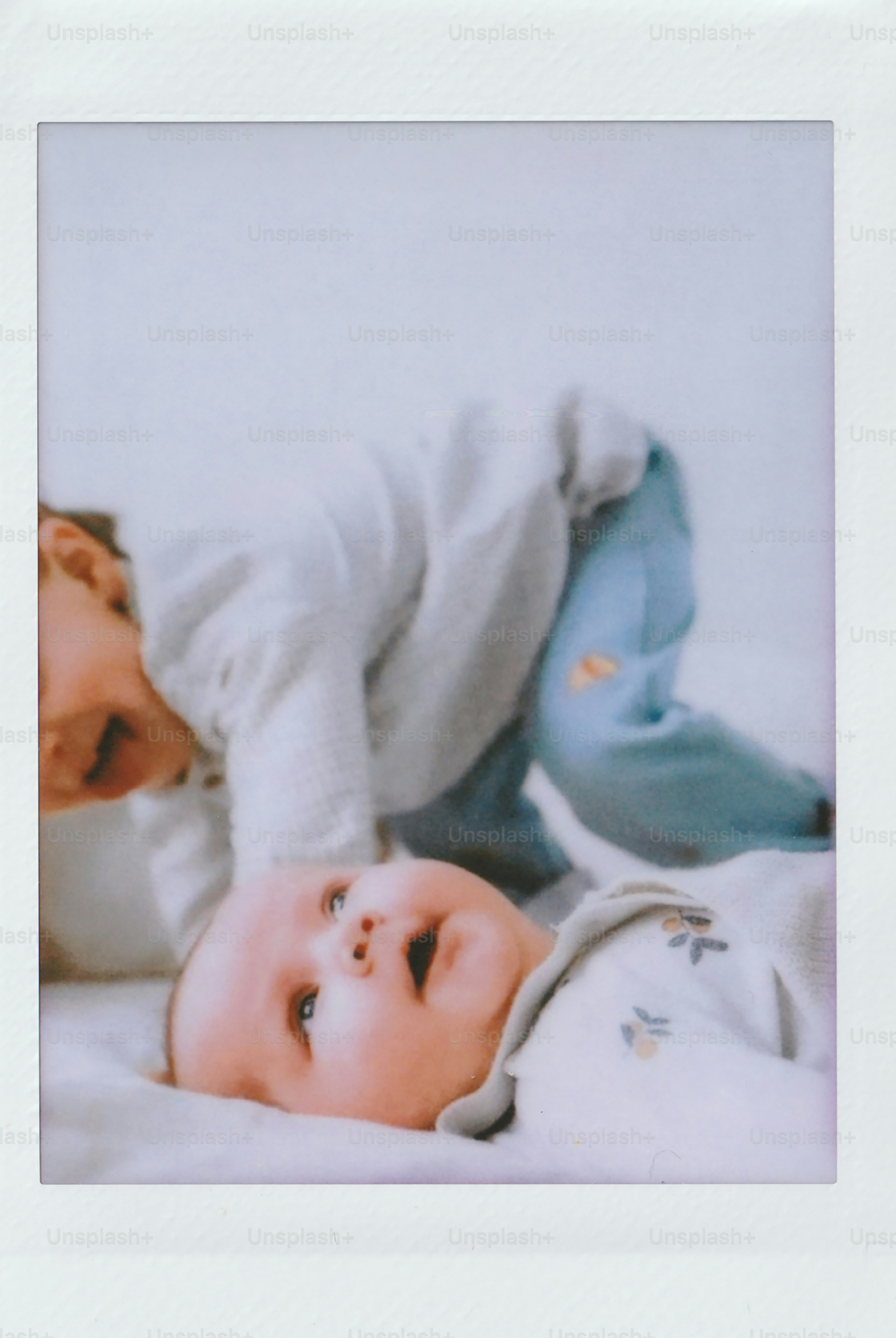 Two children playing on a white surface