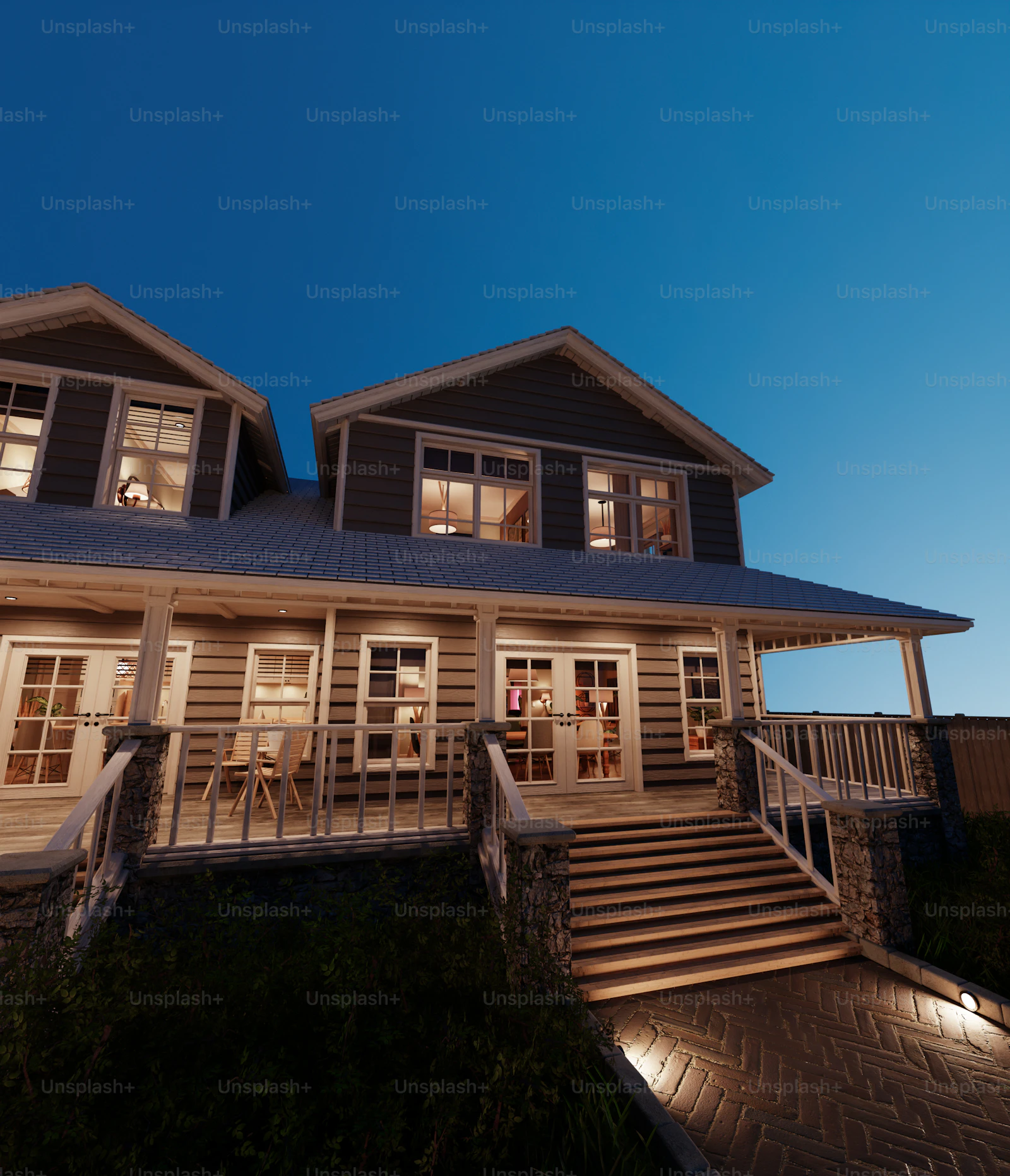 Modern mountain home with a covered porch glowing at dusk