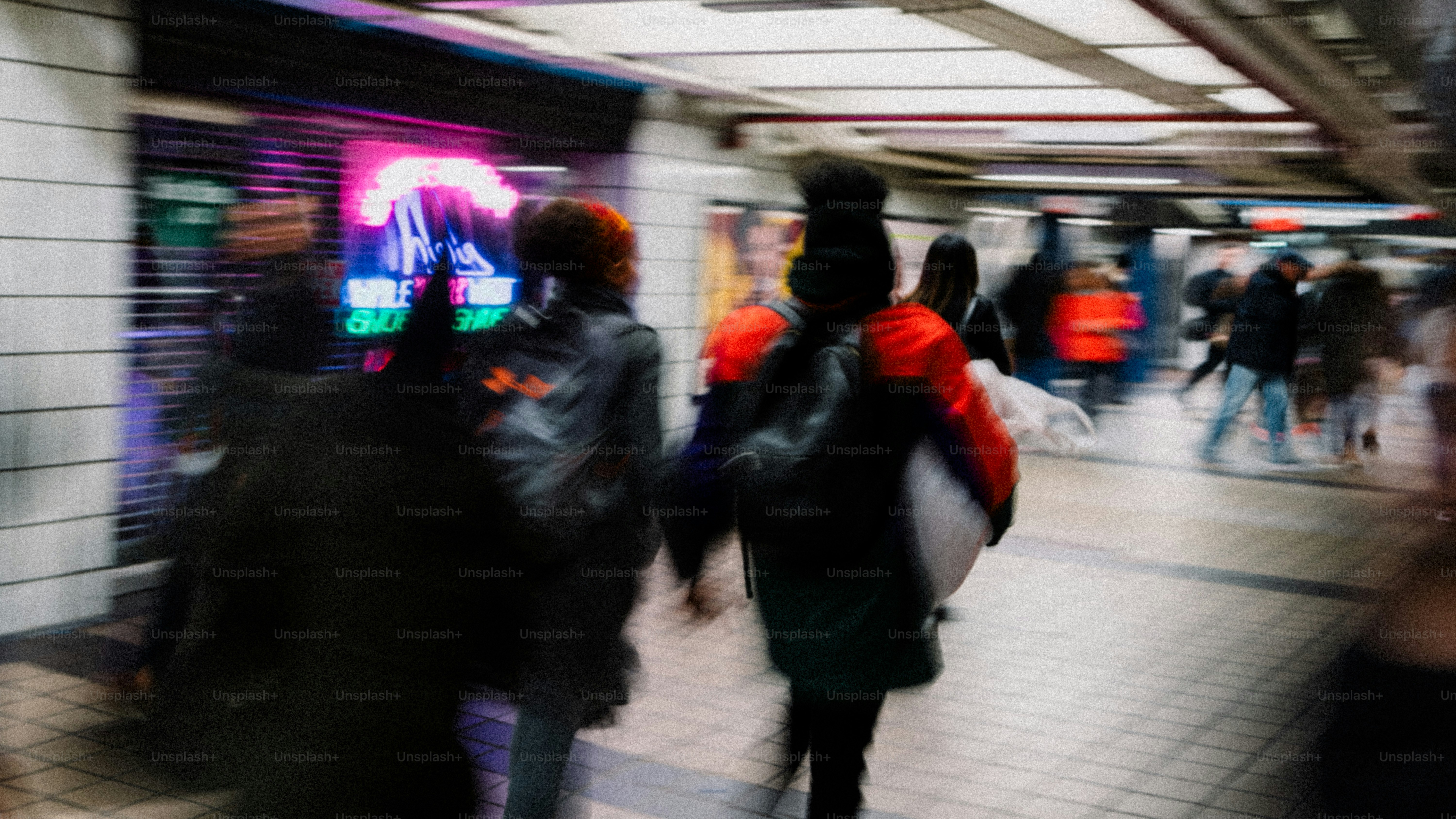 Busy subway station with motion blur and people walking to destination