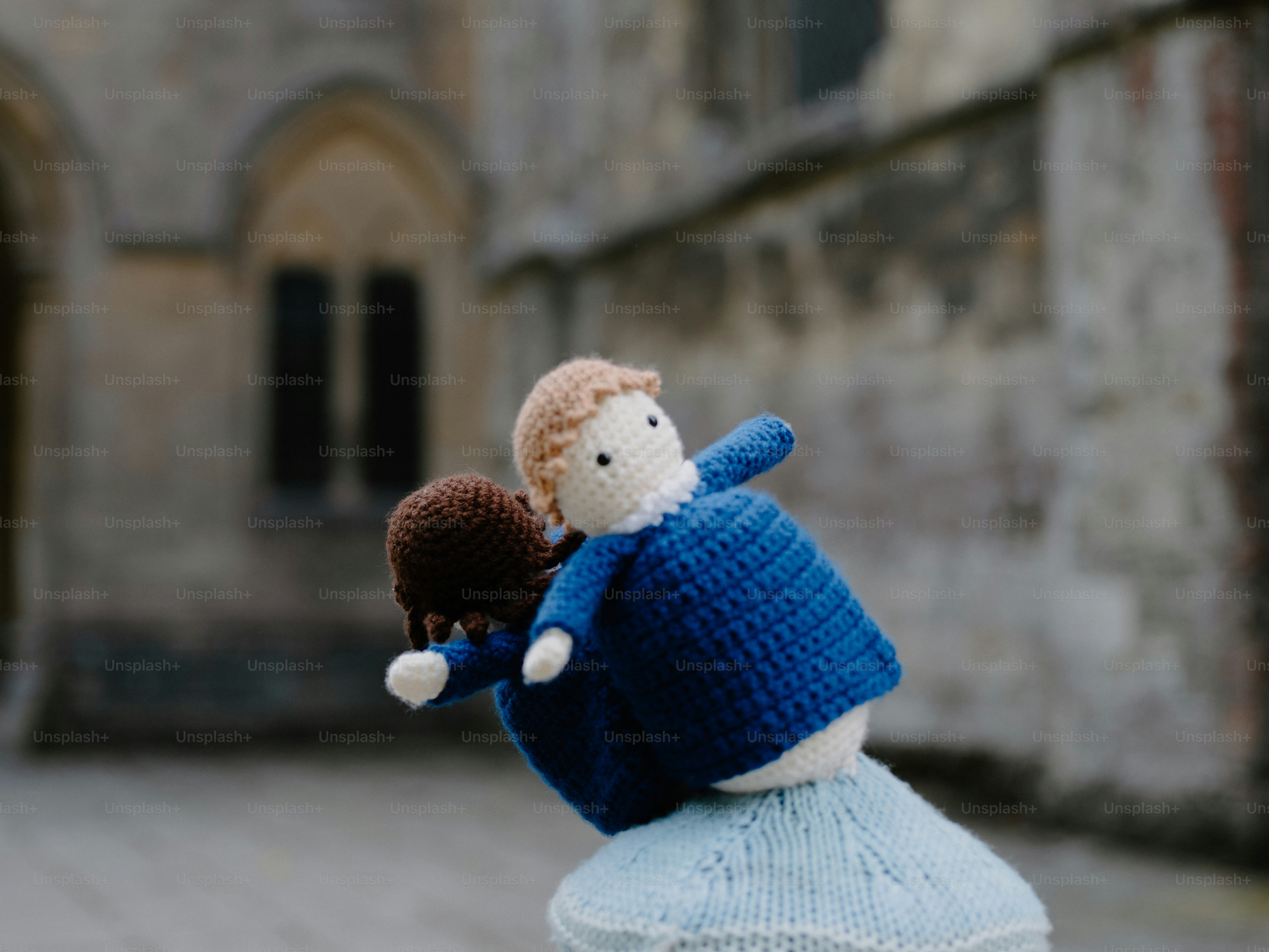 Crocheted doll with brown sheep on shoulder