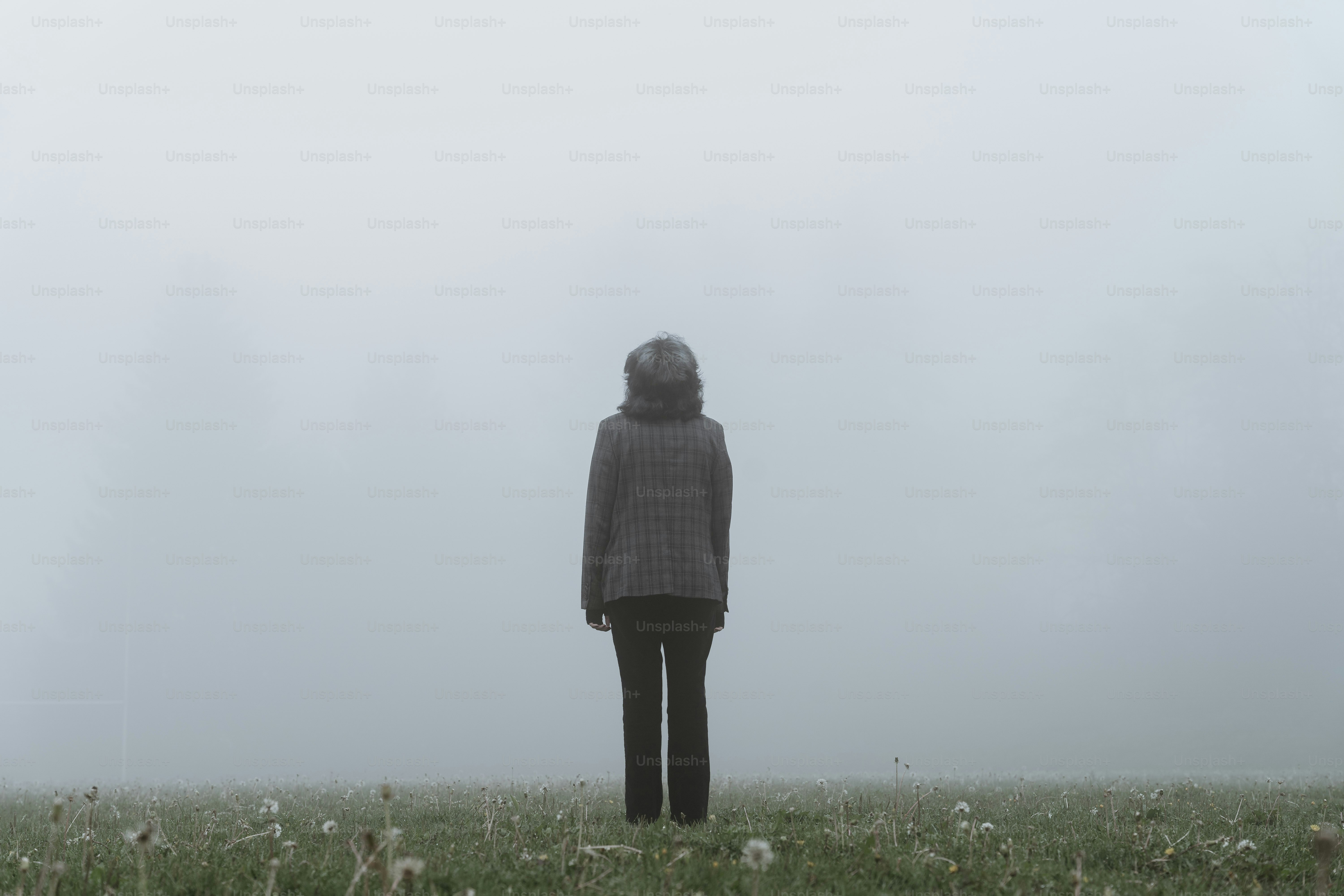 Person standing in a foggy field with flowers. photo – Dark Image on  Unsplash, image size:3000x2000