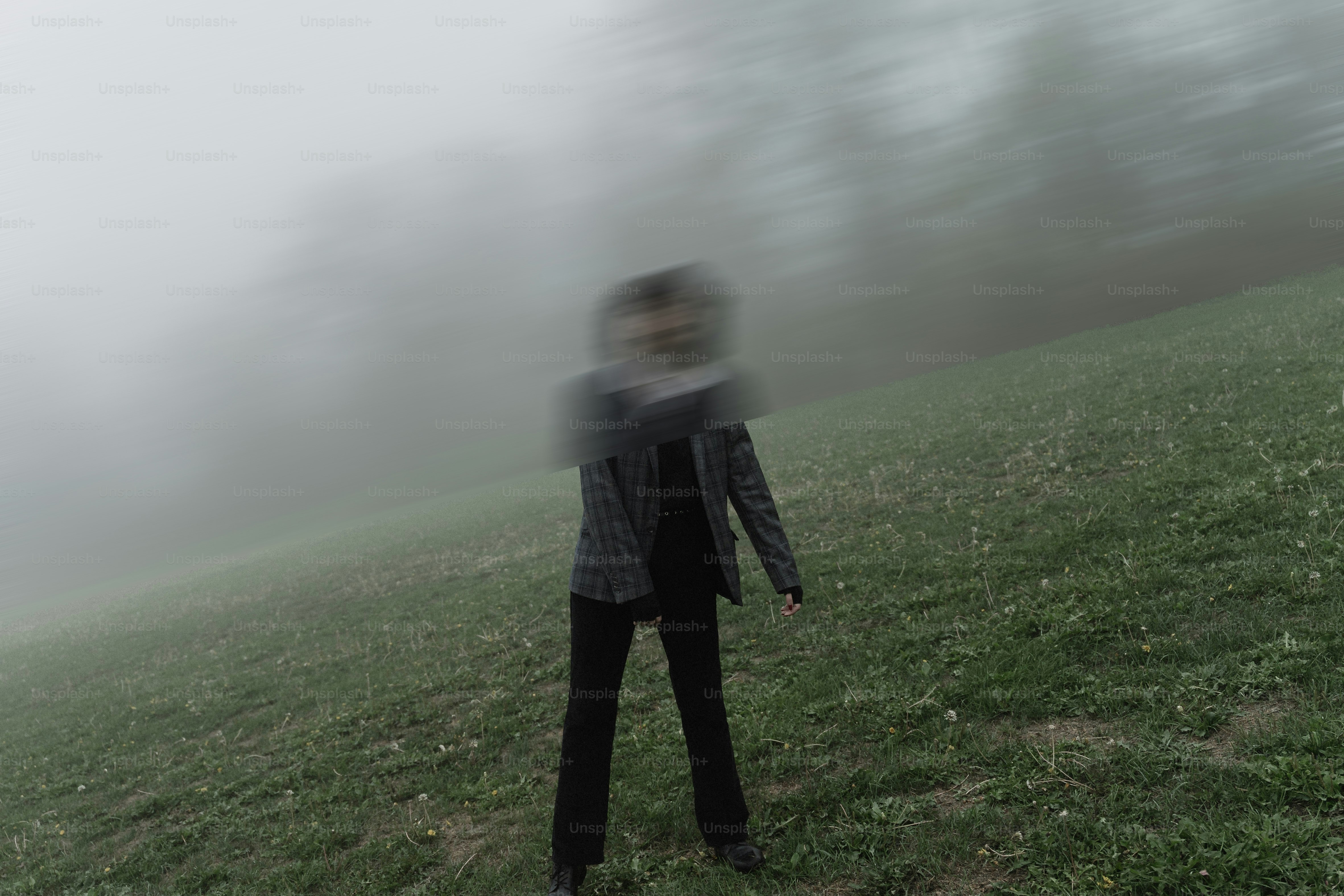 Person in fog on grassy hill