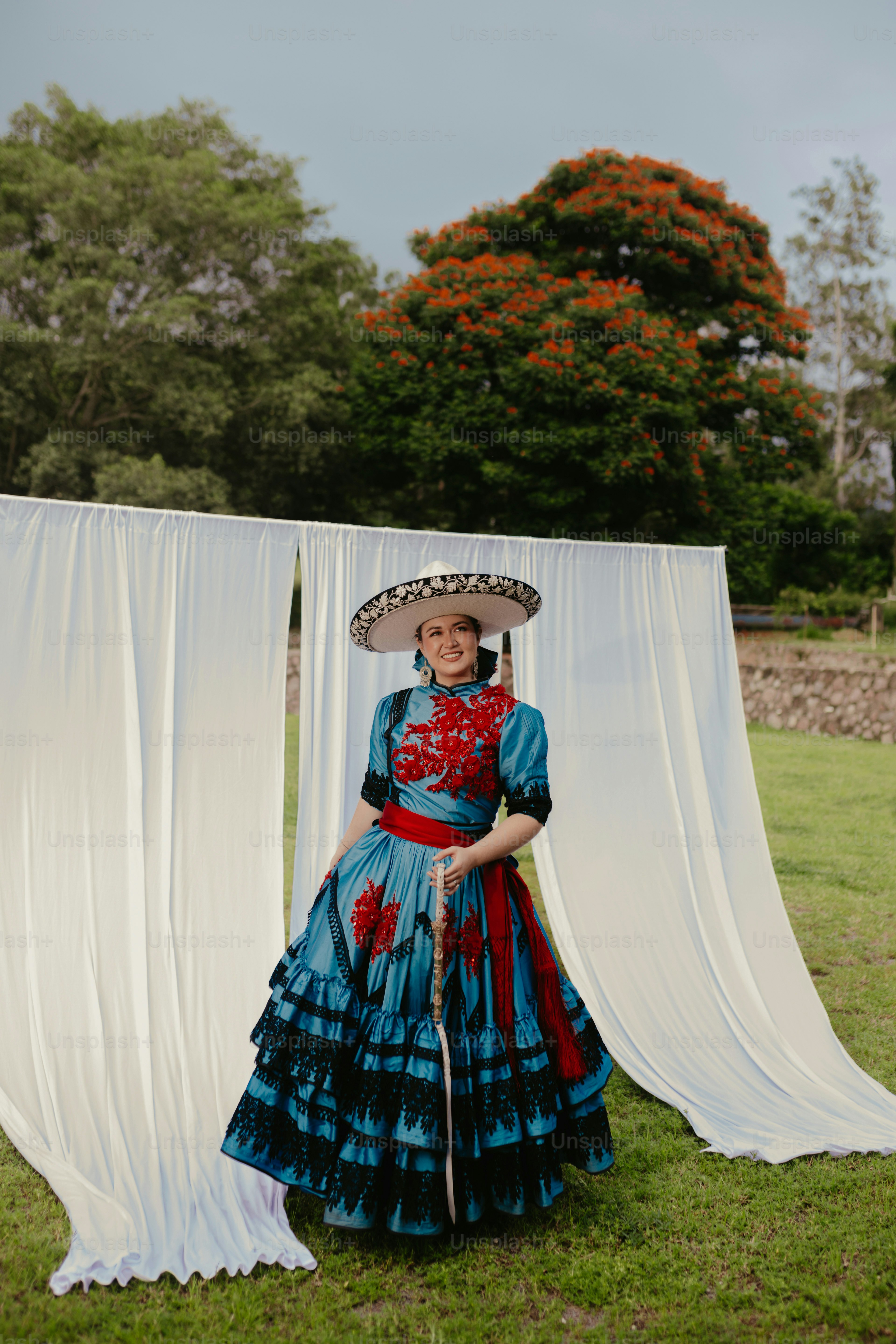 Woman in traditional mexican charro dress and sombrero