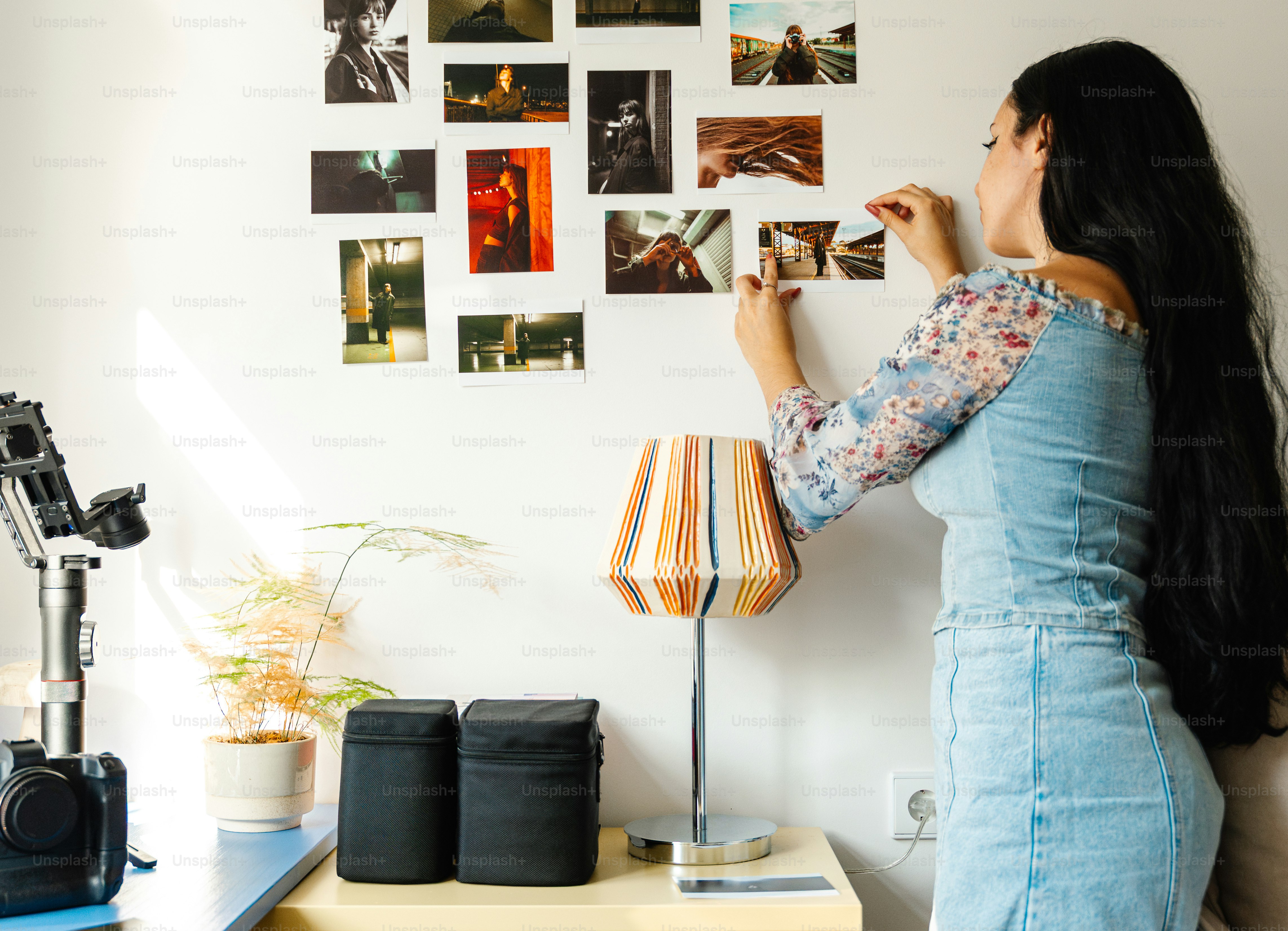 Woman arranging photos on a wall