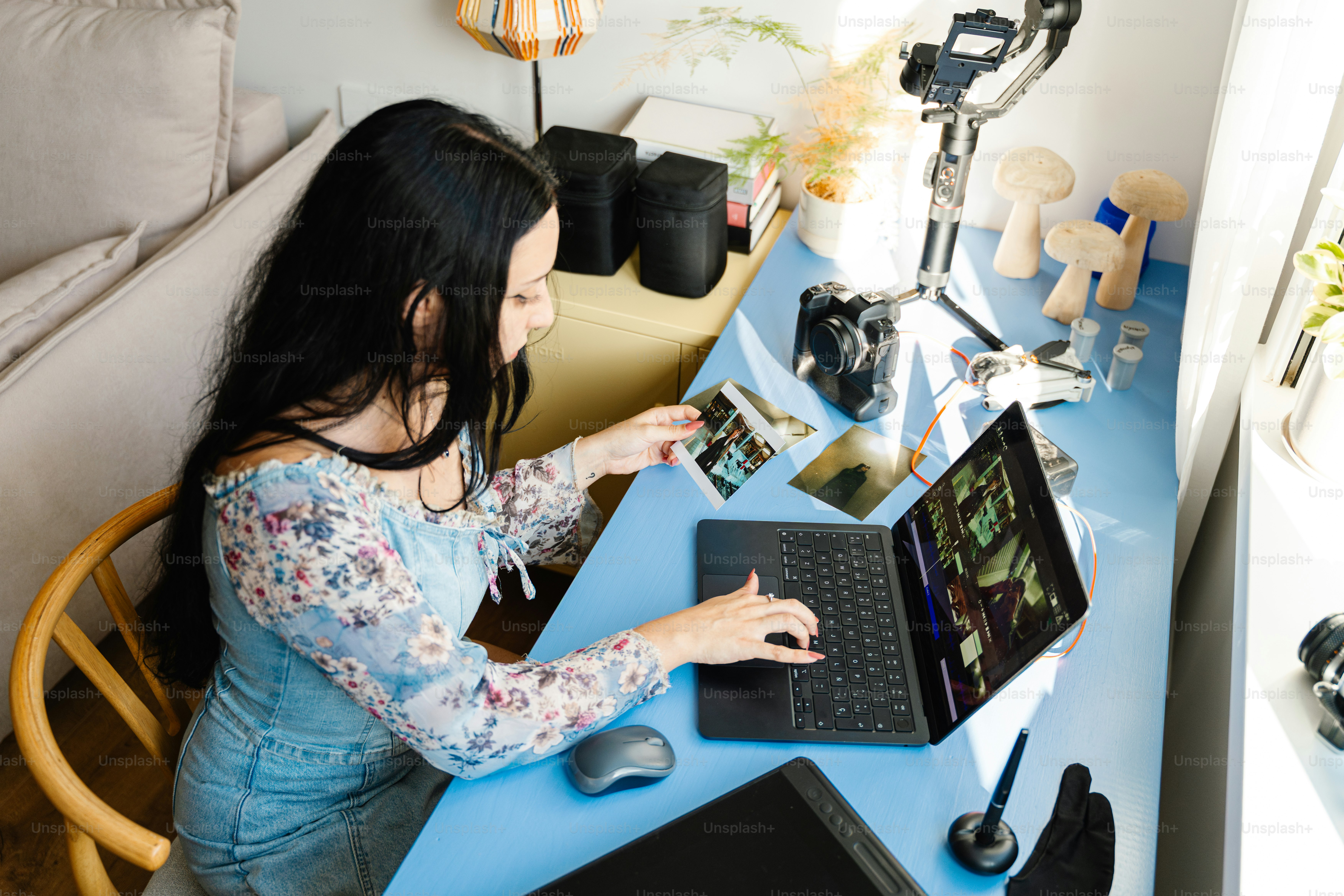 Woman editing photos on laptop at desk