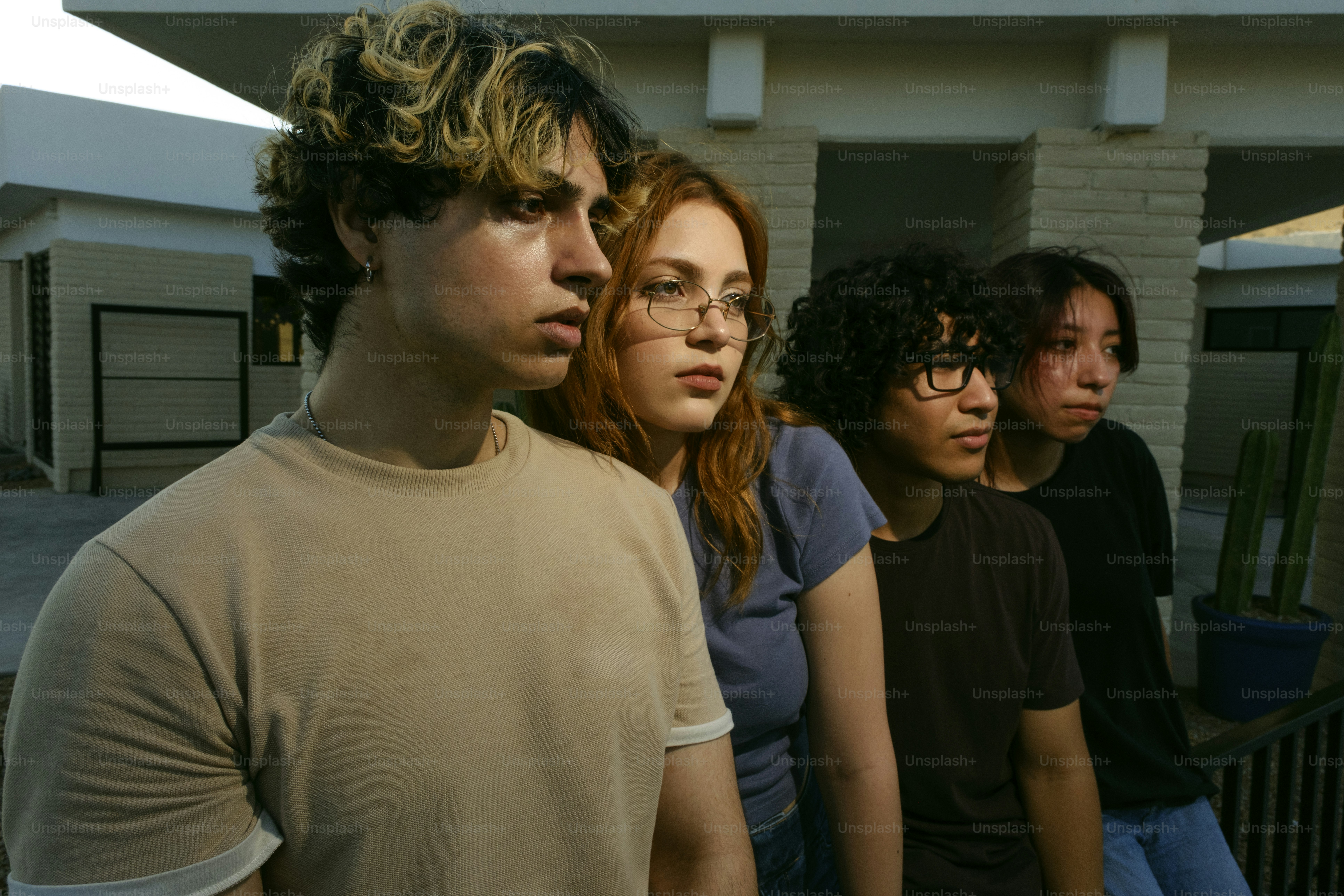 Four young people look into the distance together.