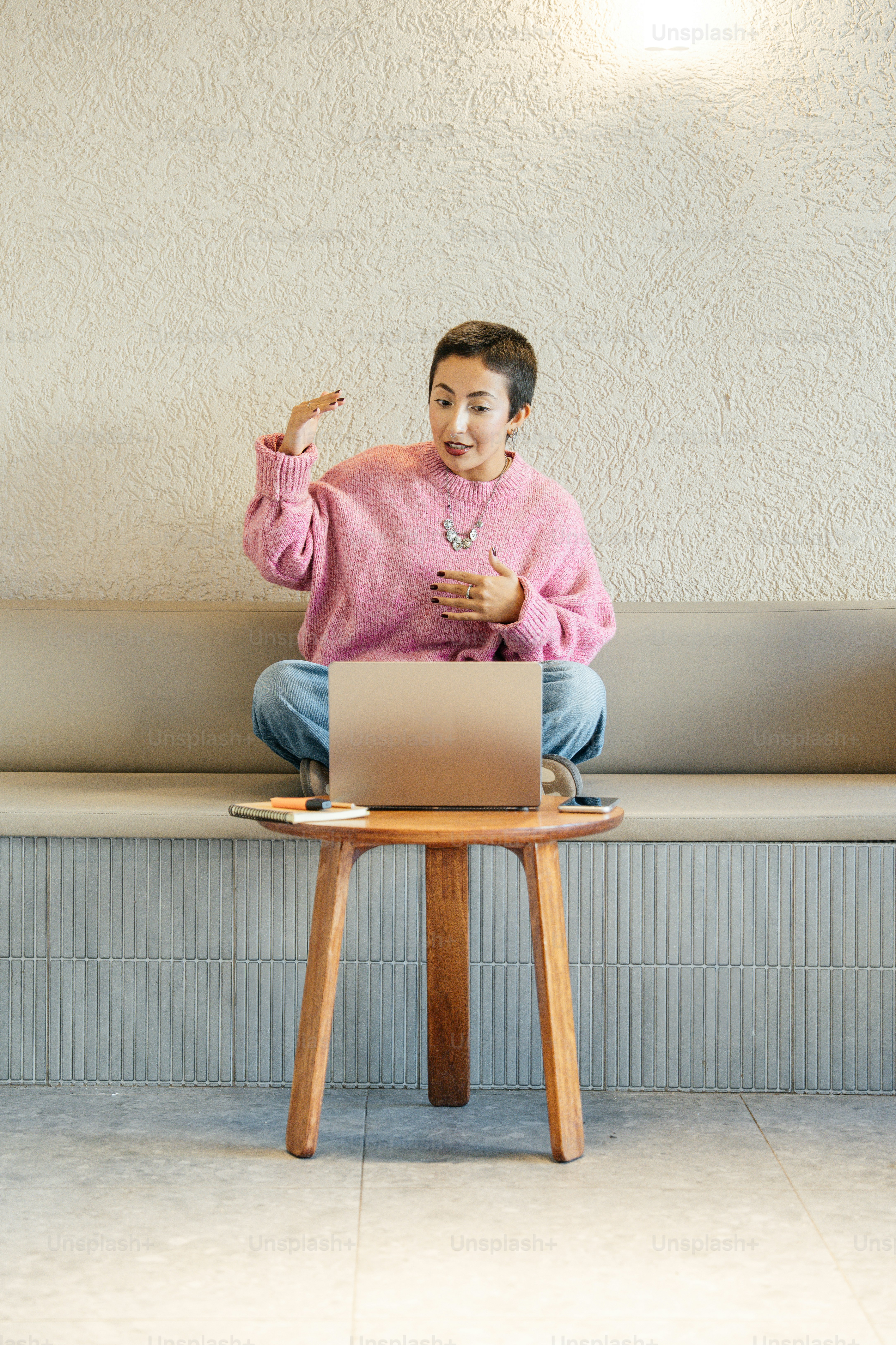 Woman gestures while talking on a video call on laptop. photo ...