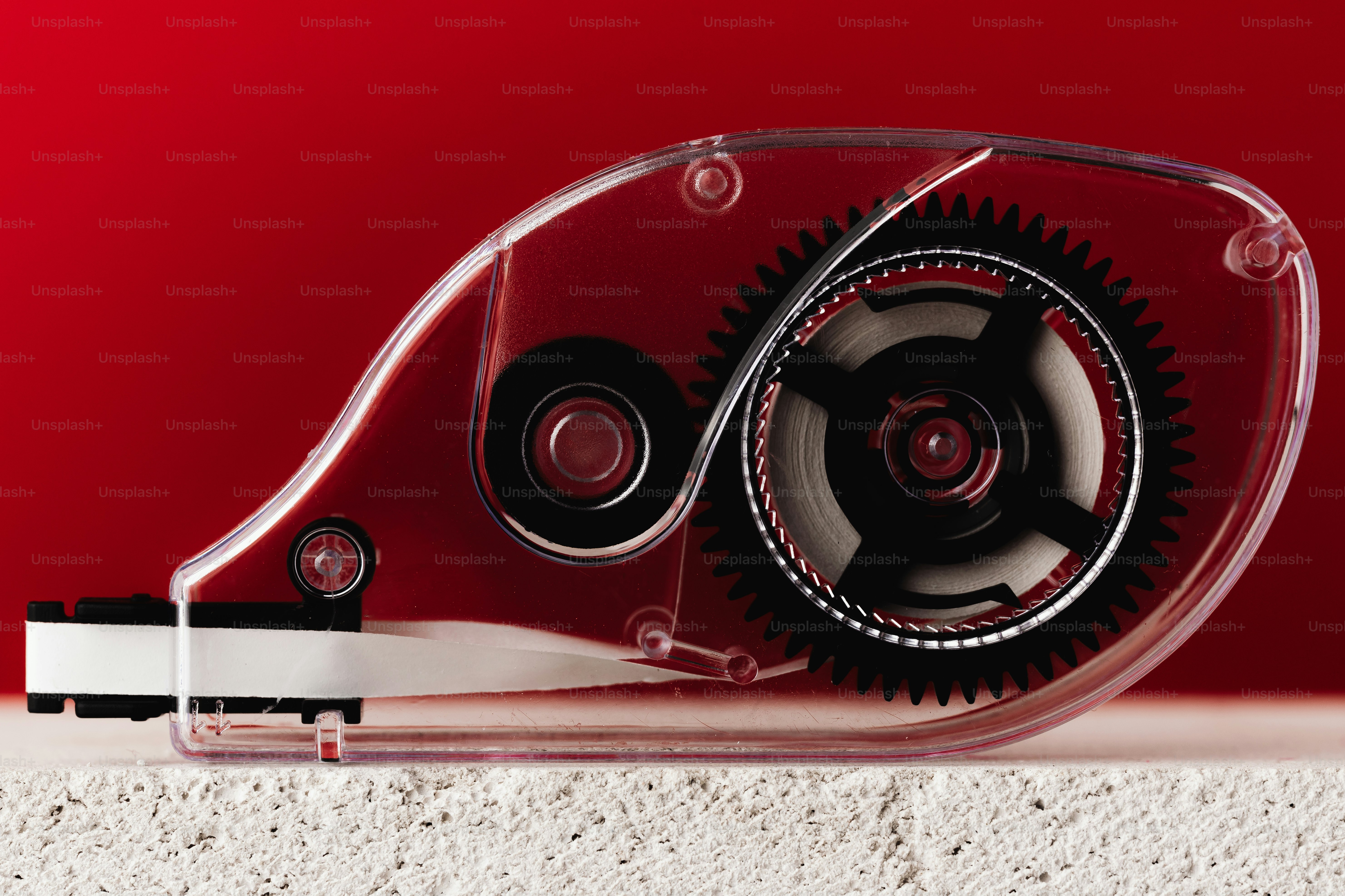 Transparent correction tape dispenser with gears.