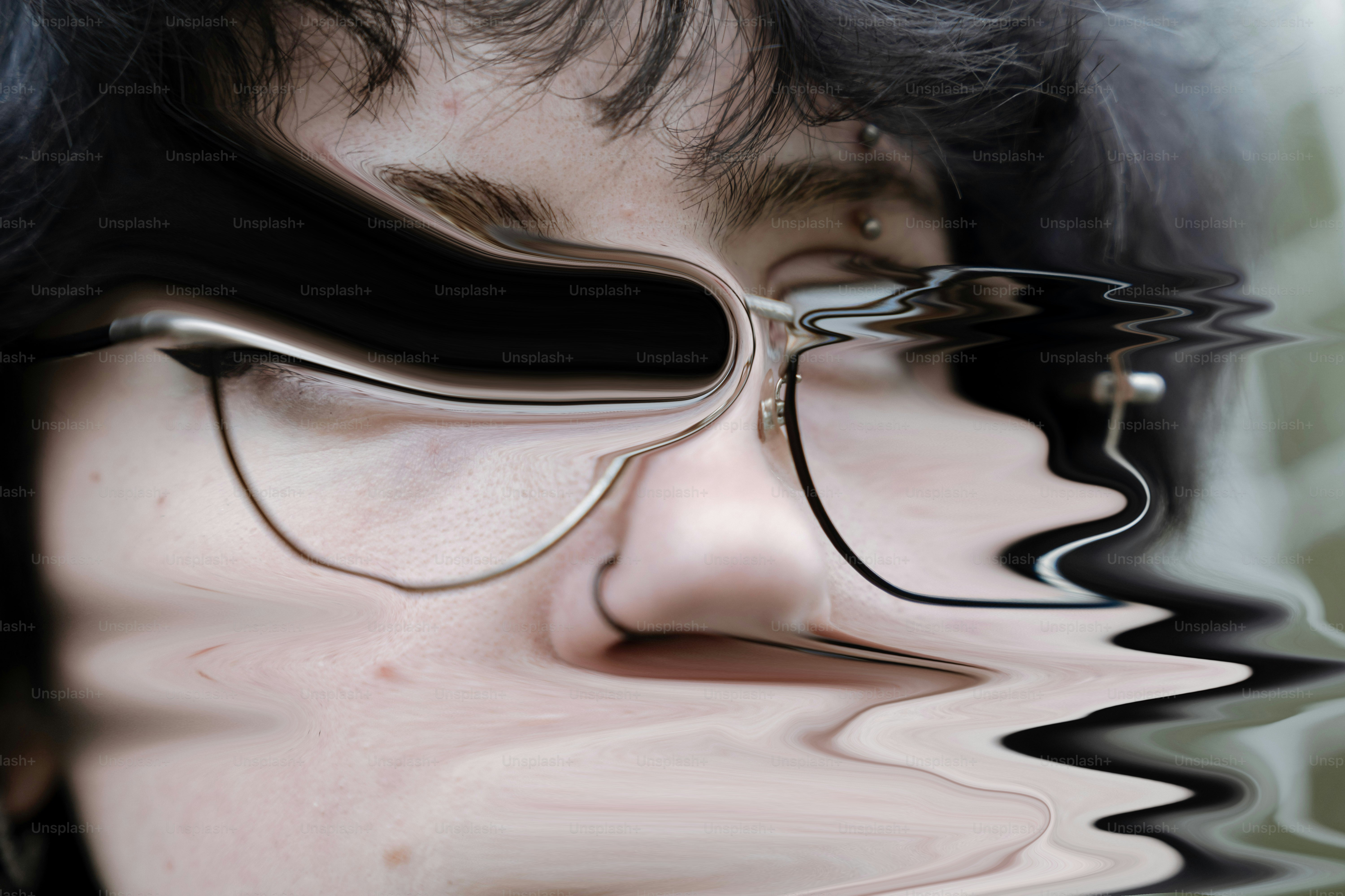 Distorted face wearing glasses with water ripples