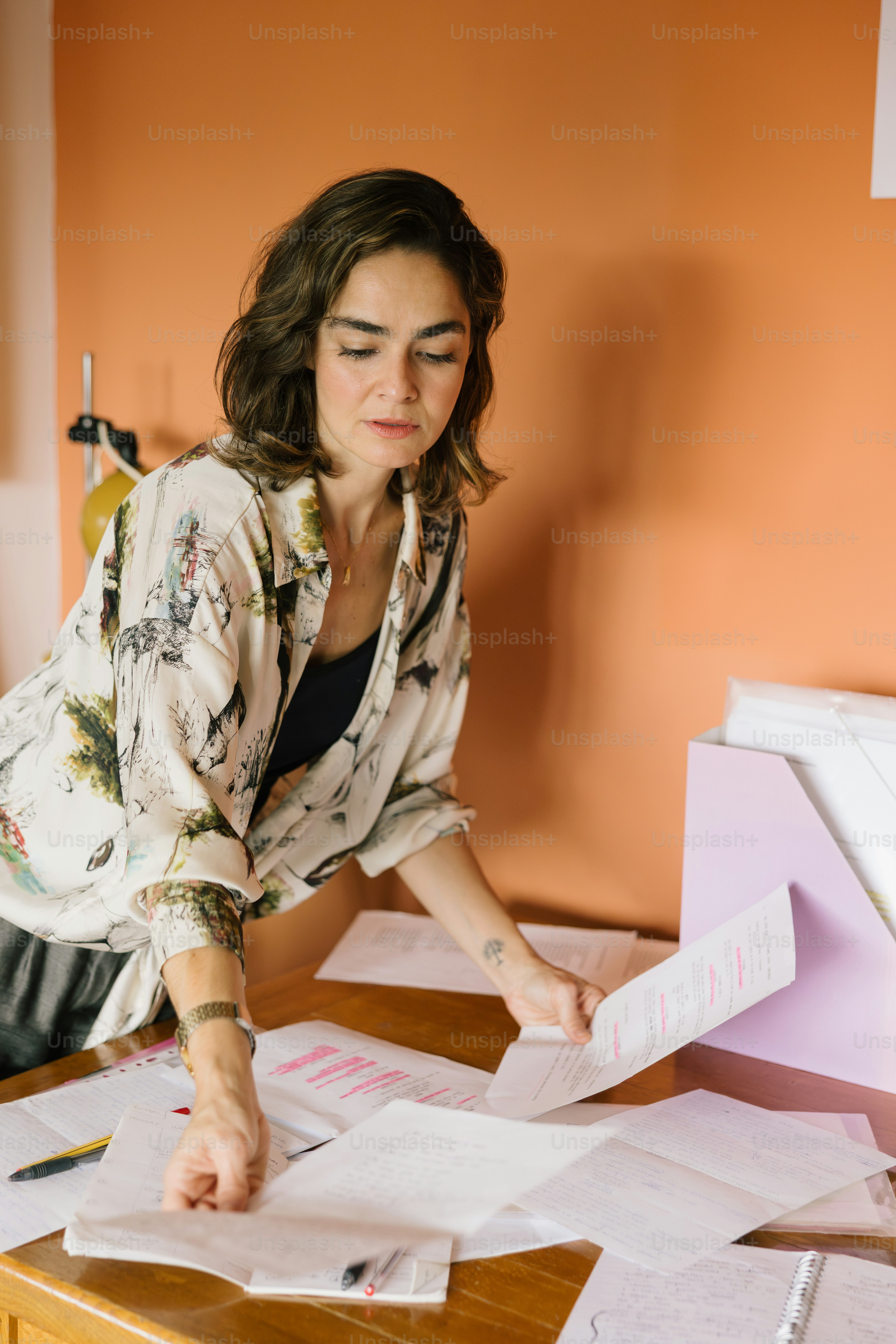 Woman looking at papers on a desk
