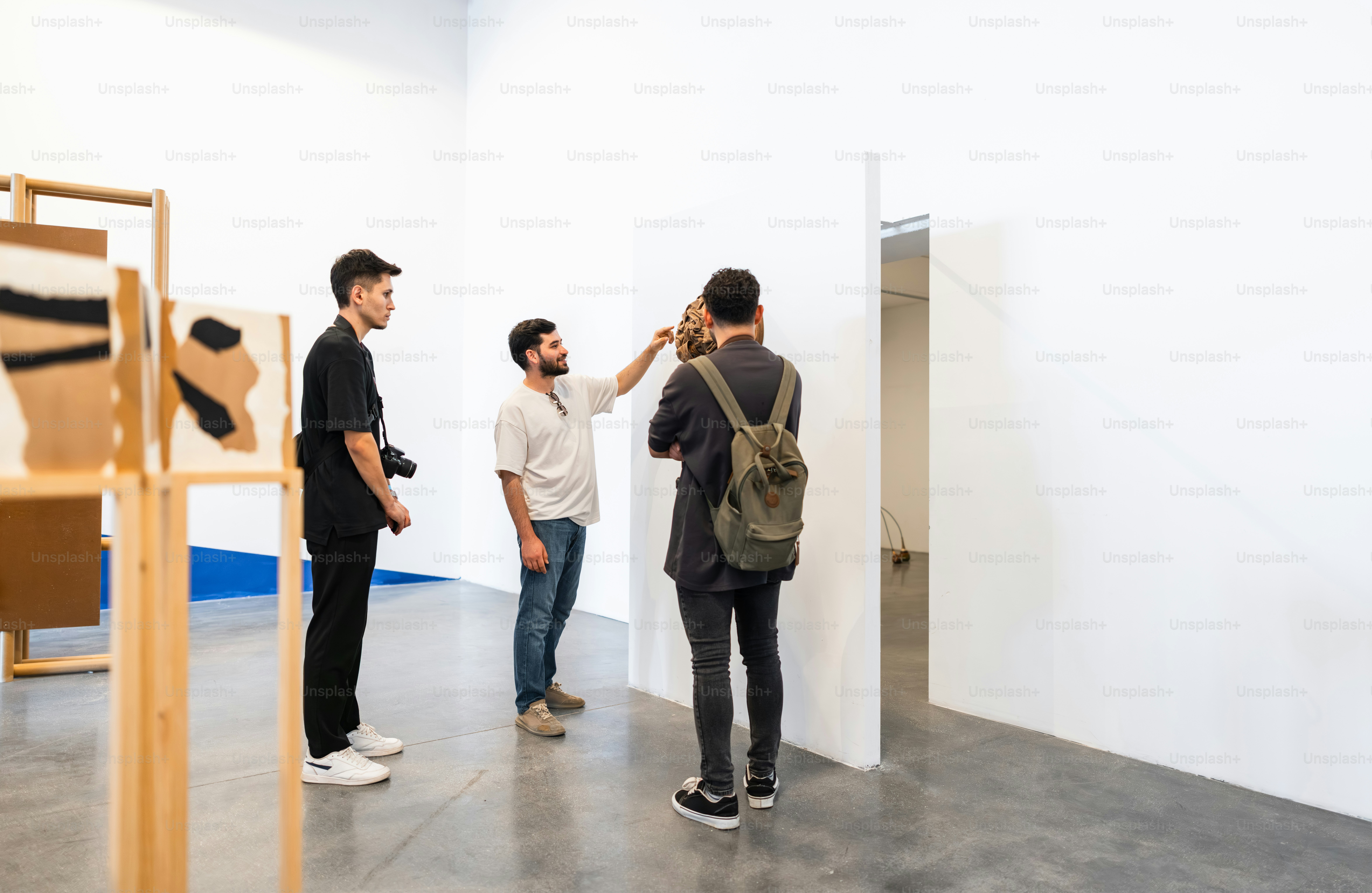 People looking at art in a modern gallery.