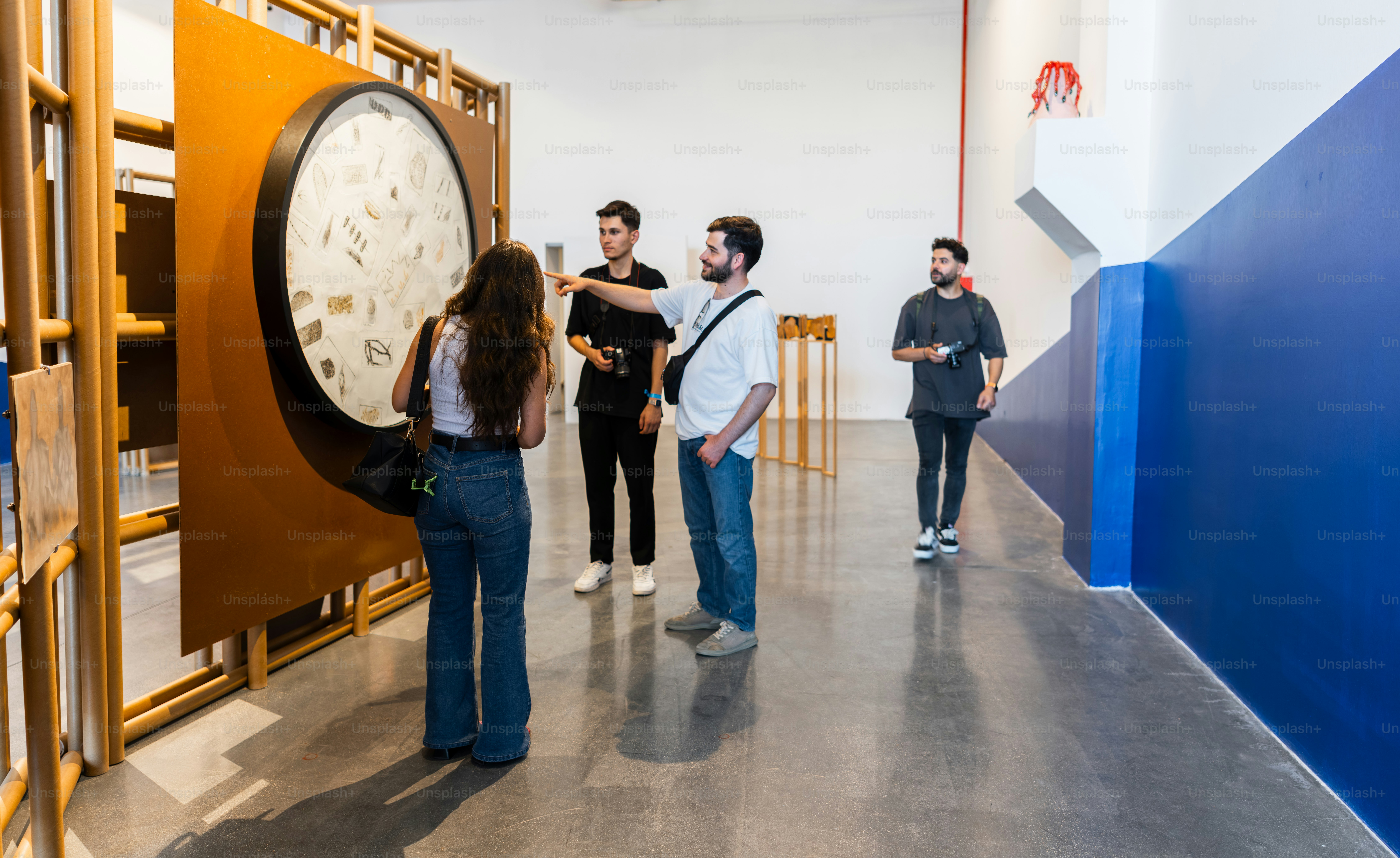 People viewing art in a modern museum exhibit.