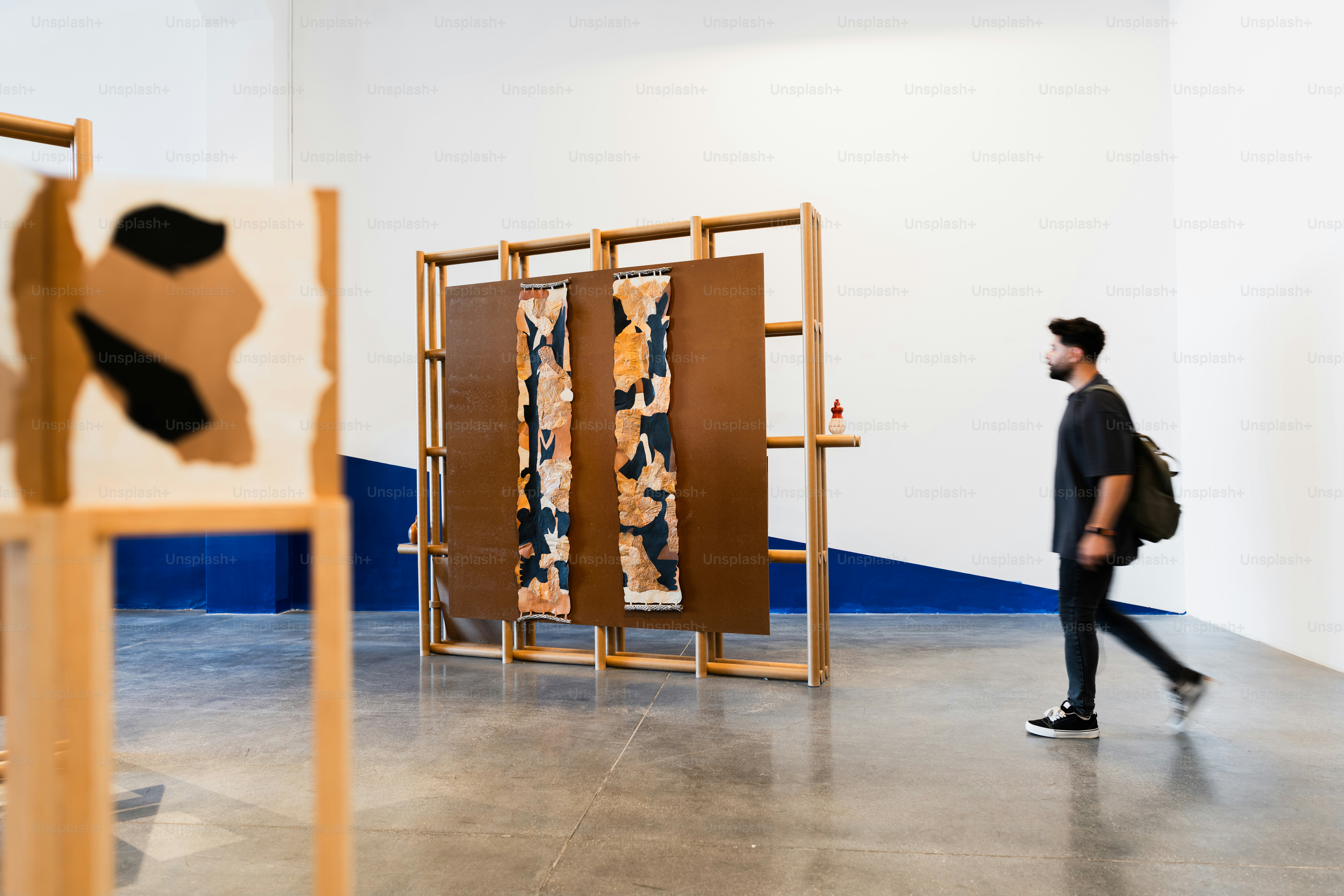 Man walking through an art gallery exhibition