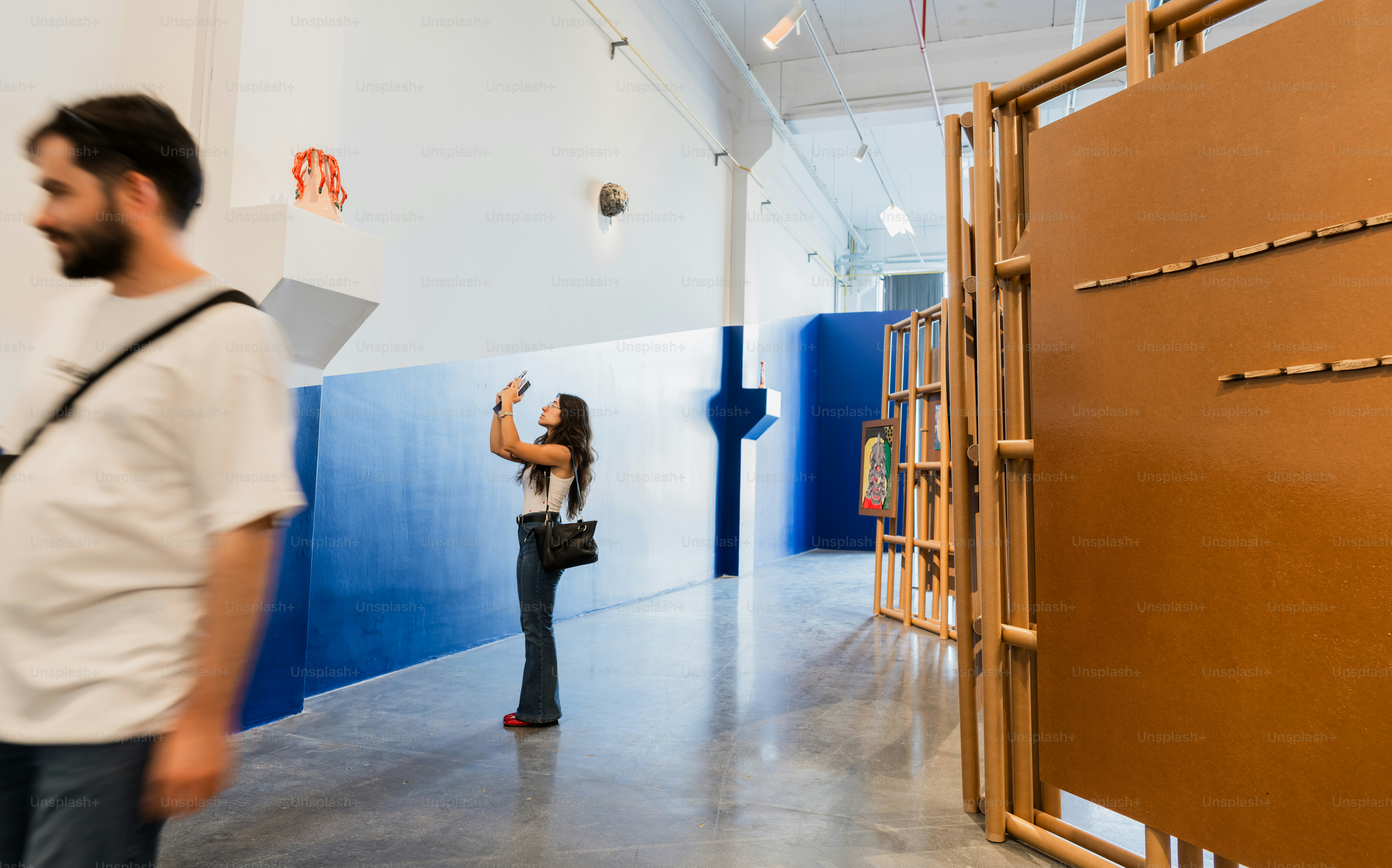Woman taking a picture in a modern art gallery.
