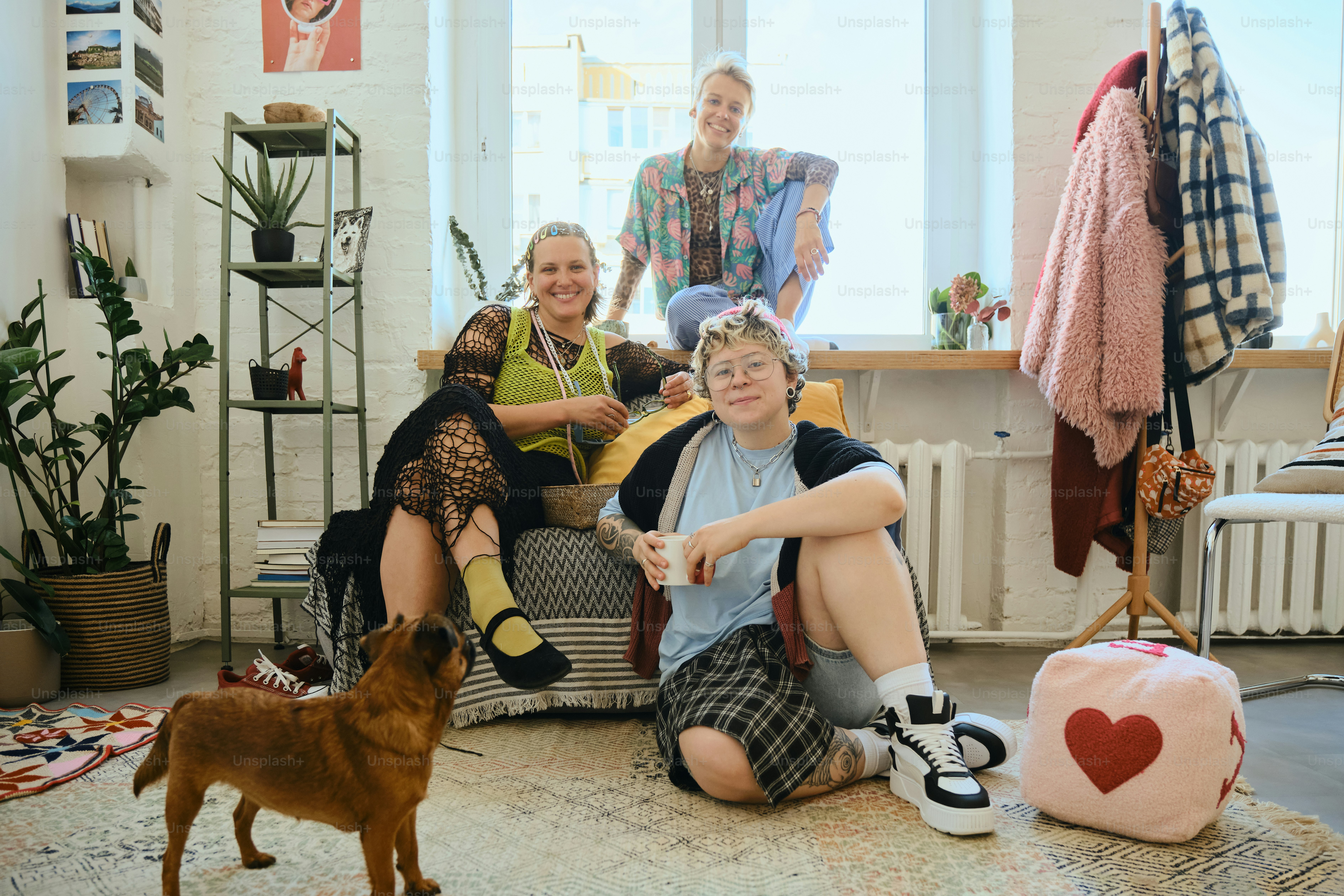 Three friends and a dog in a cozy room.