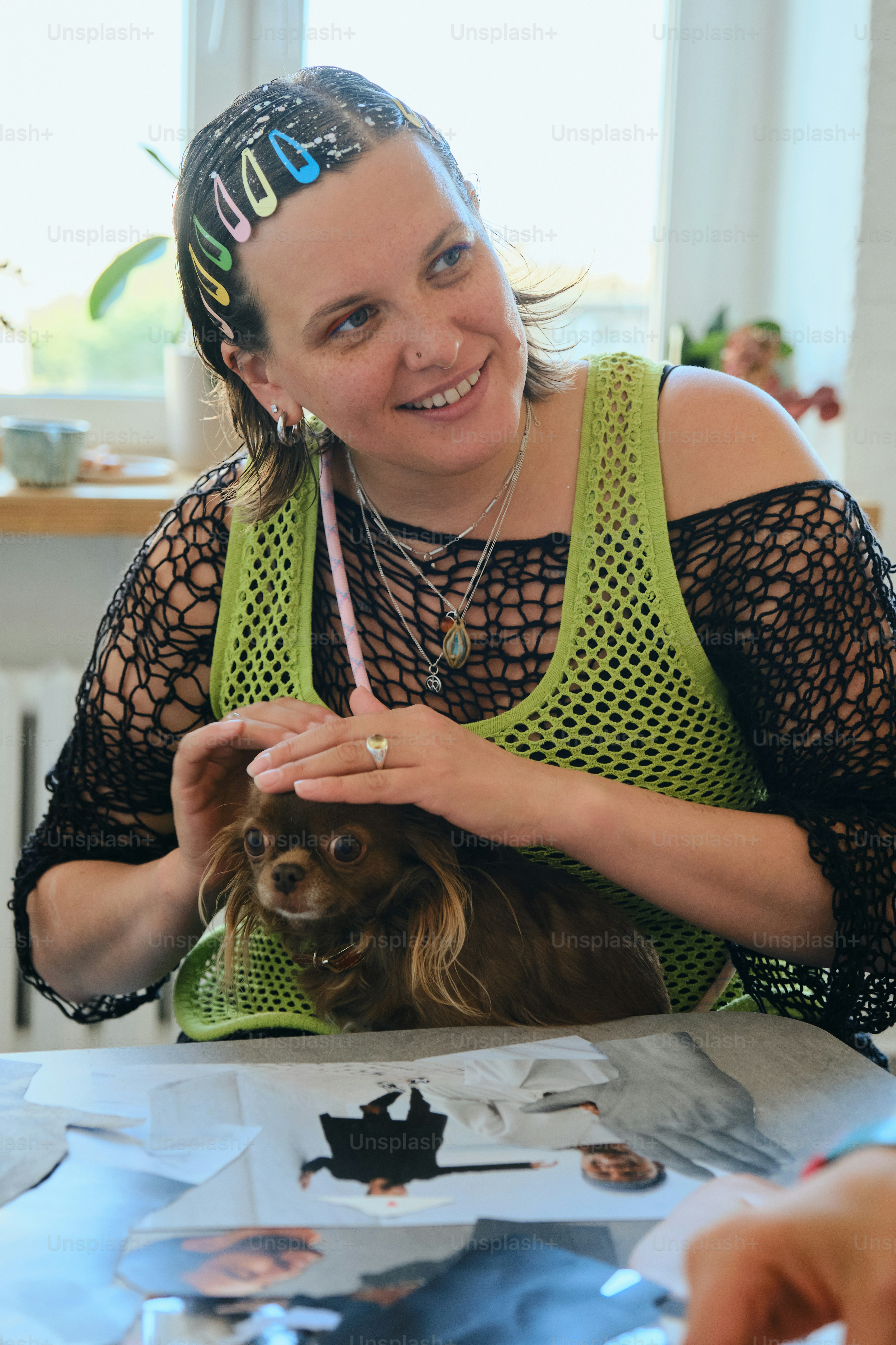 Woman with small dog wearing colorful hair clips