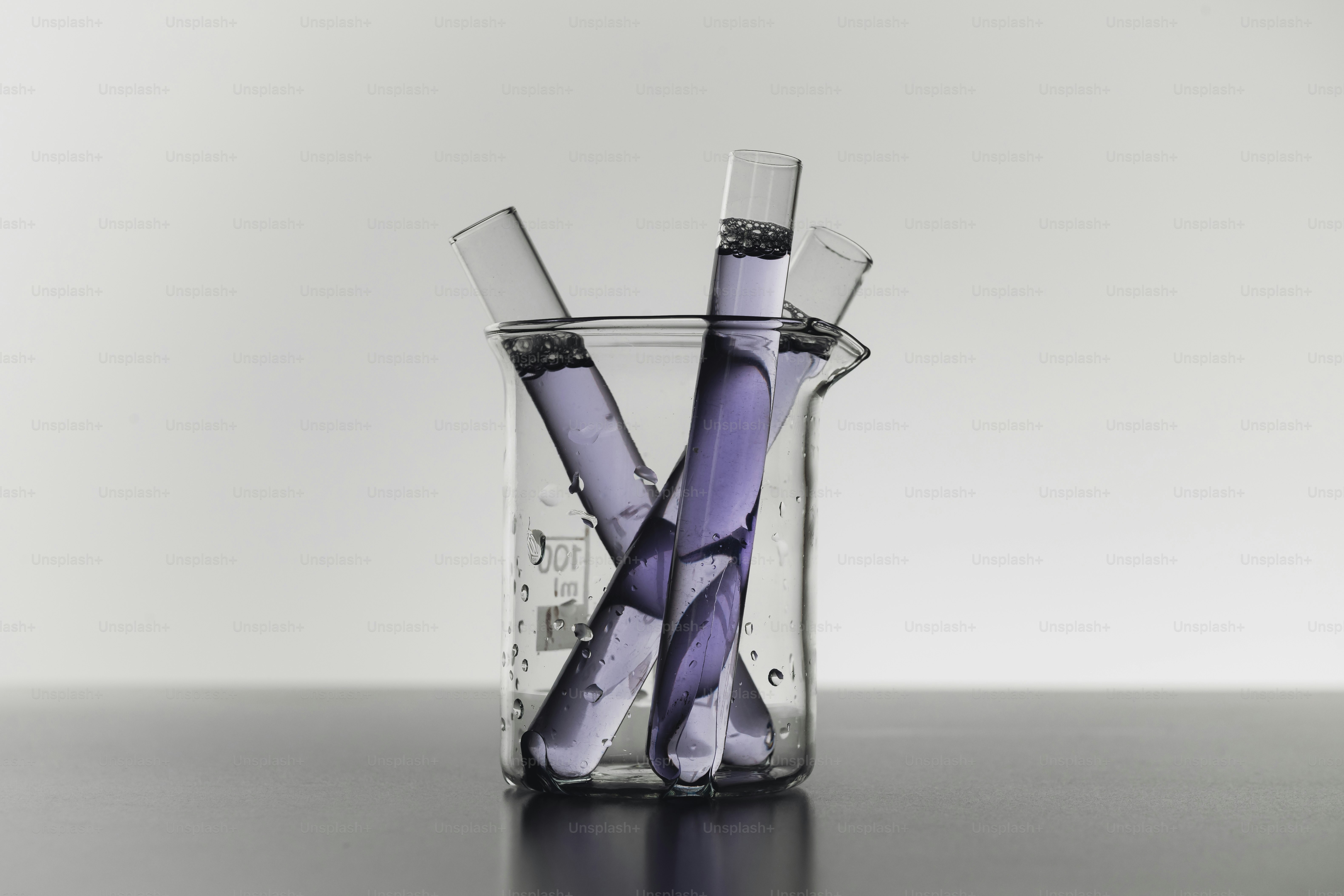 Dropper adding liquid to blue solution in beaker photo – Science Image ...