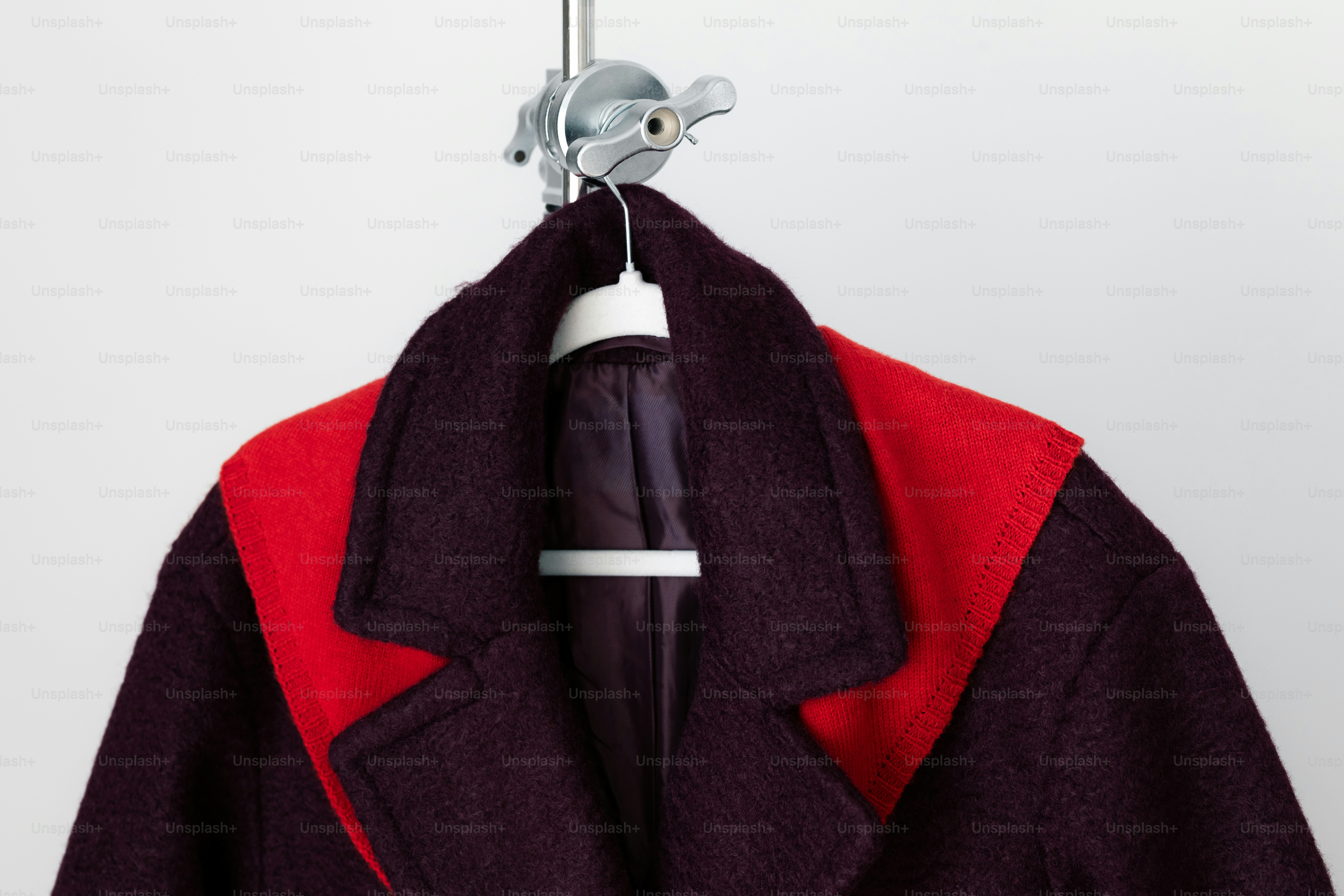 Dark wool coat with red accents on collar