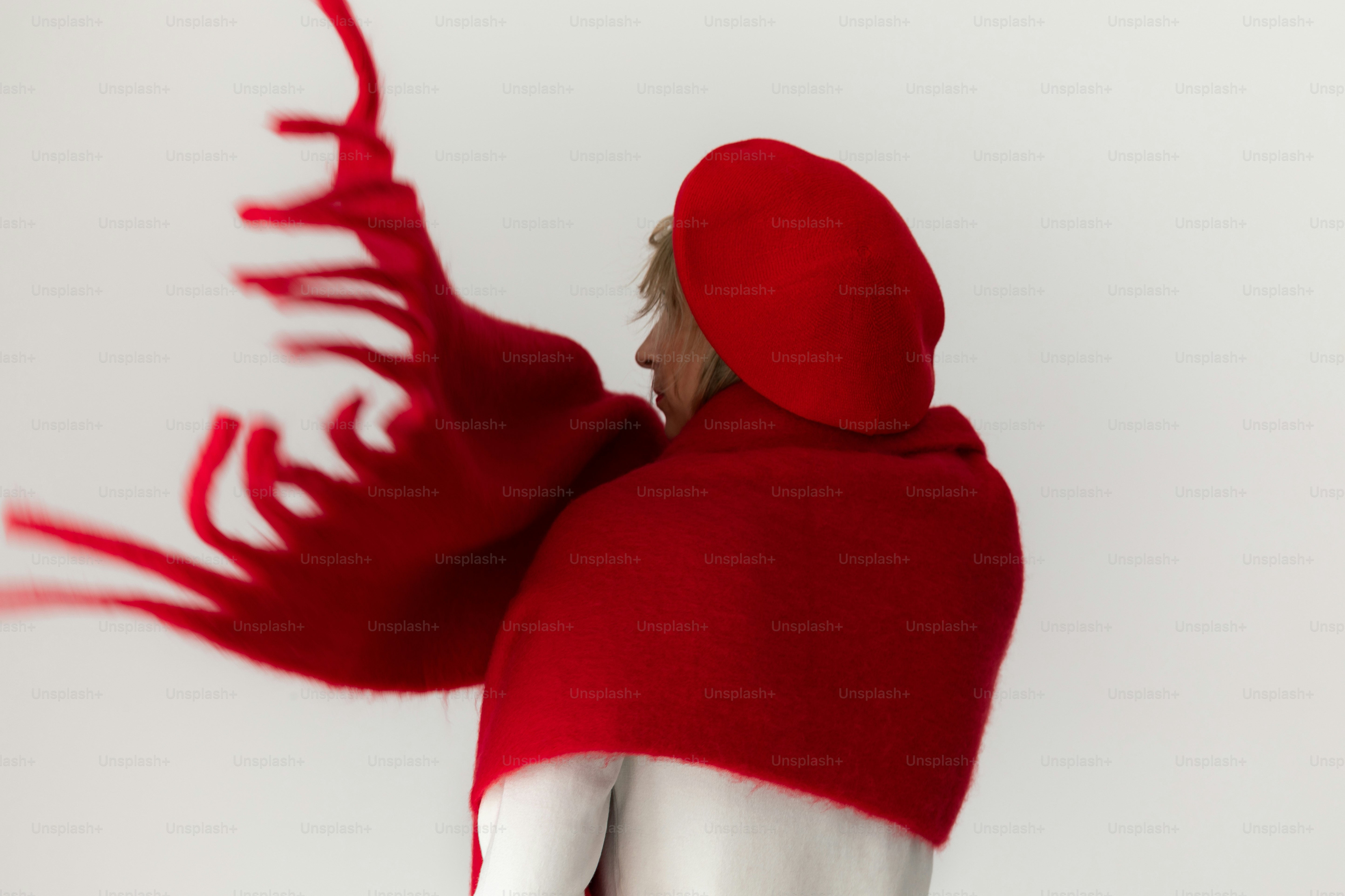 Woman in red scarf with flowing fringe