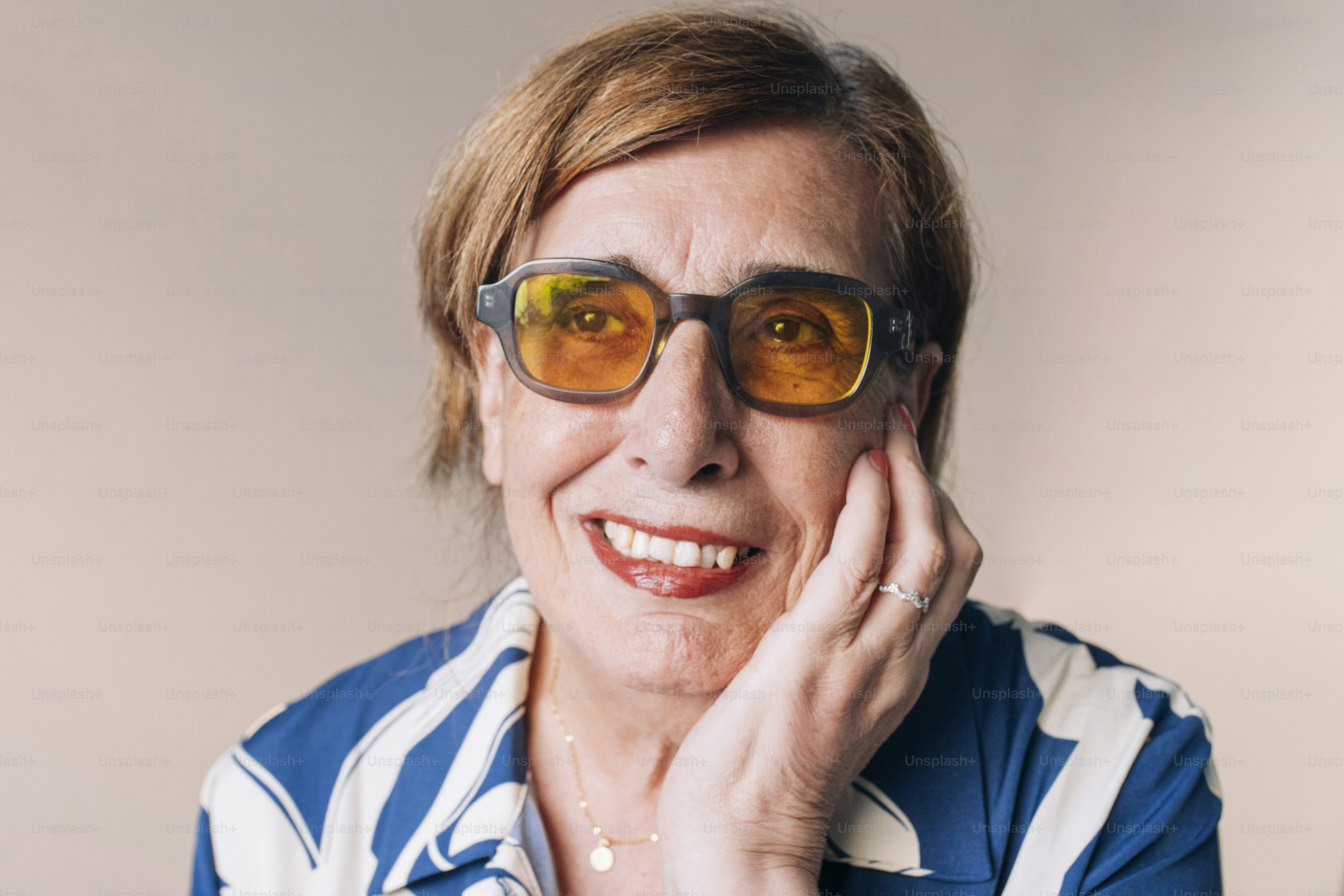 Frau mit Brille und gestreiftem Hemd lächelt