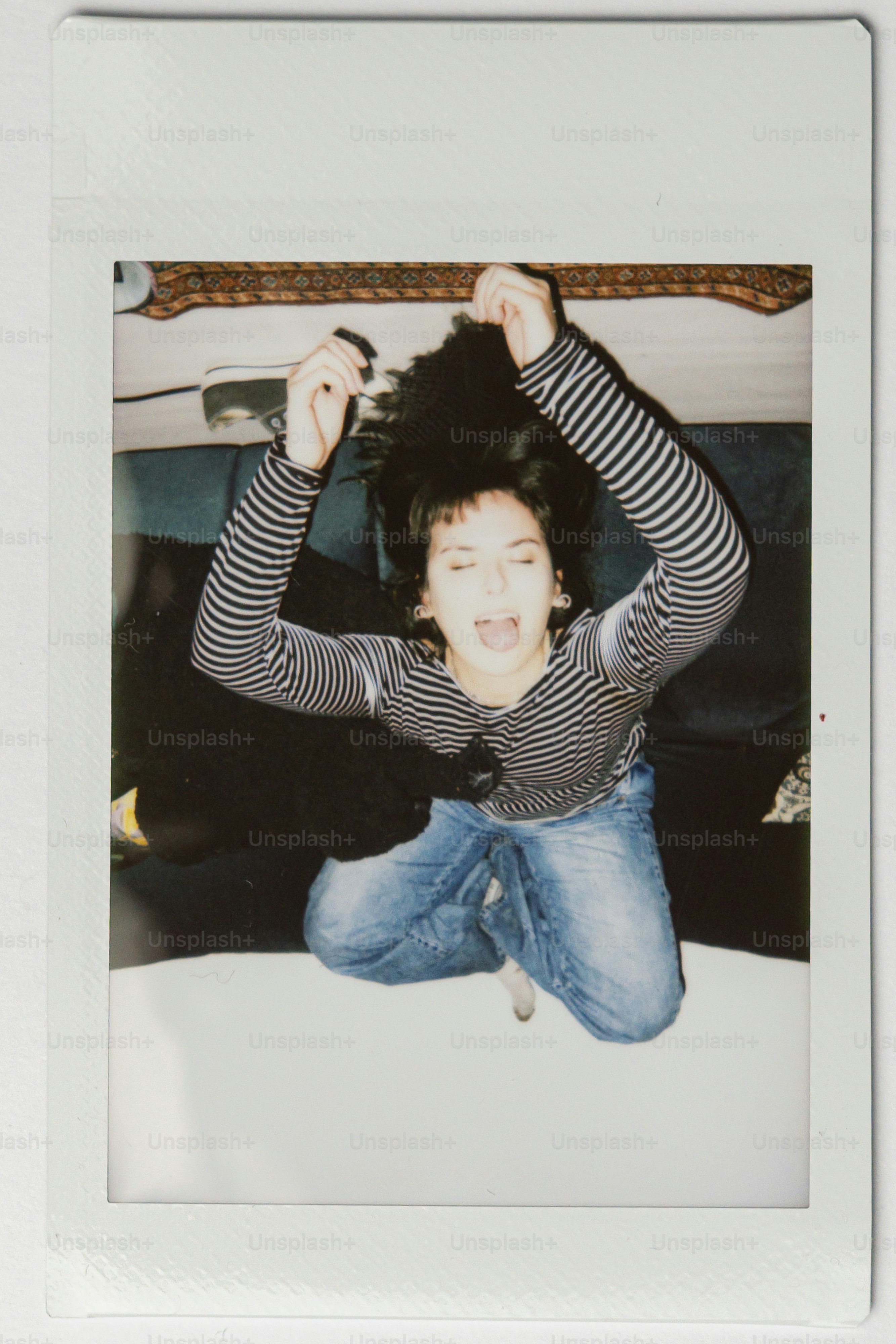 Young woman with dark hair in striped shirt, jeans