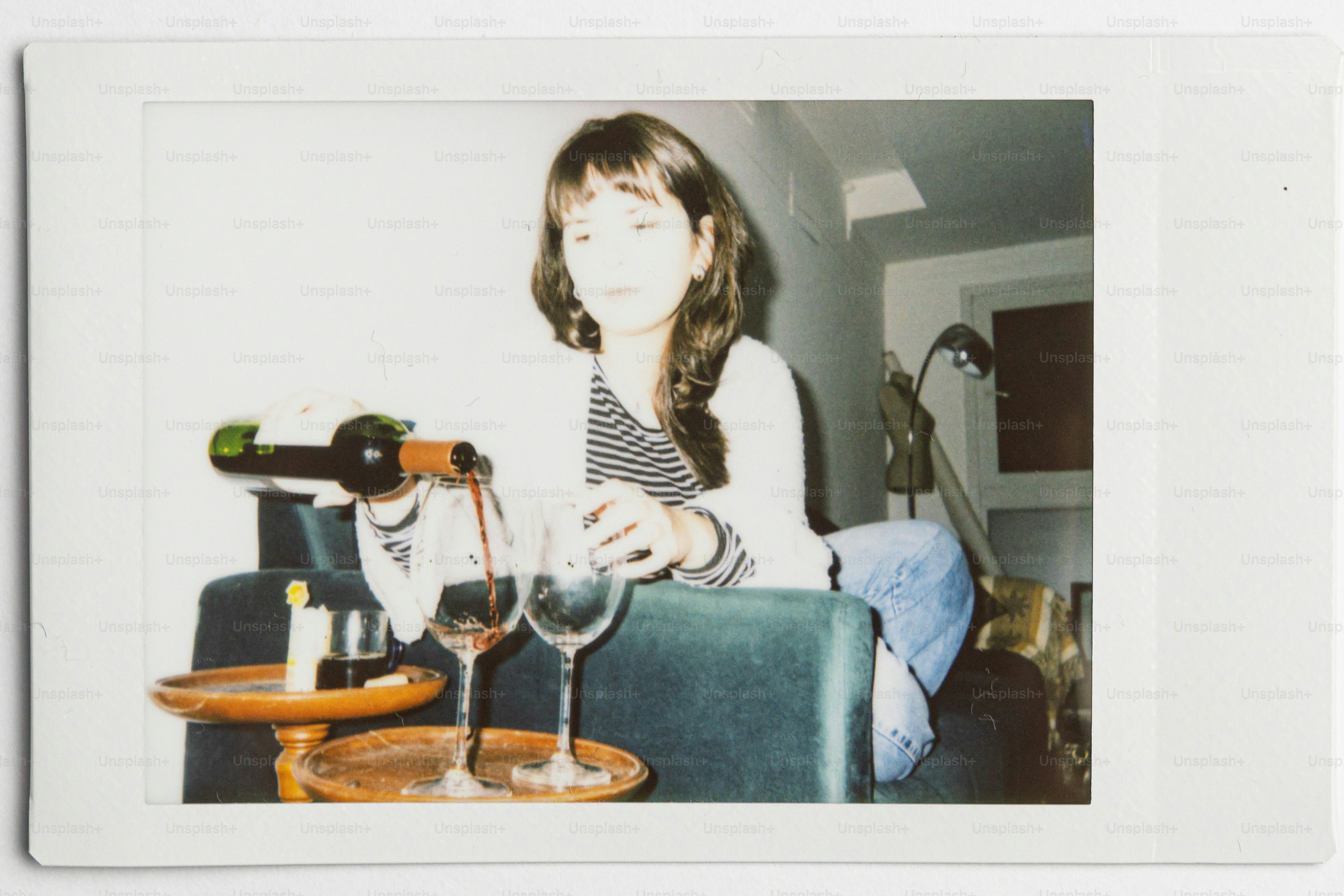 Woman pouring red wine into two glasses