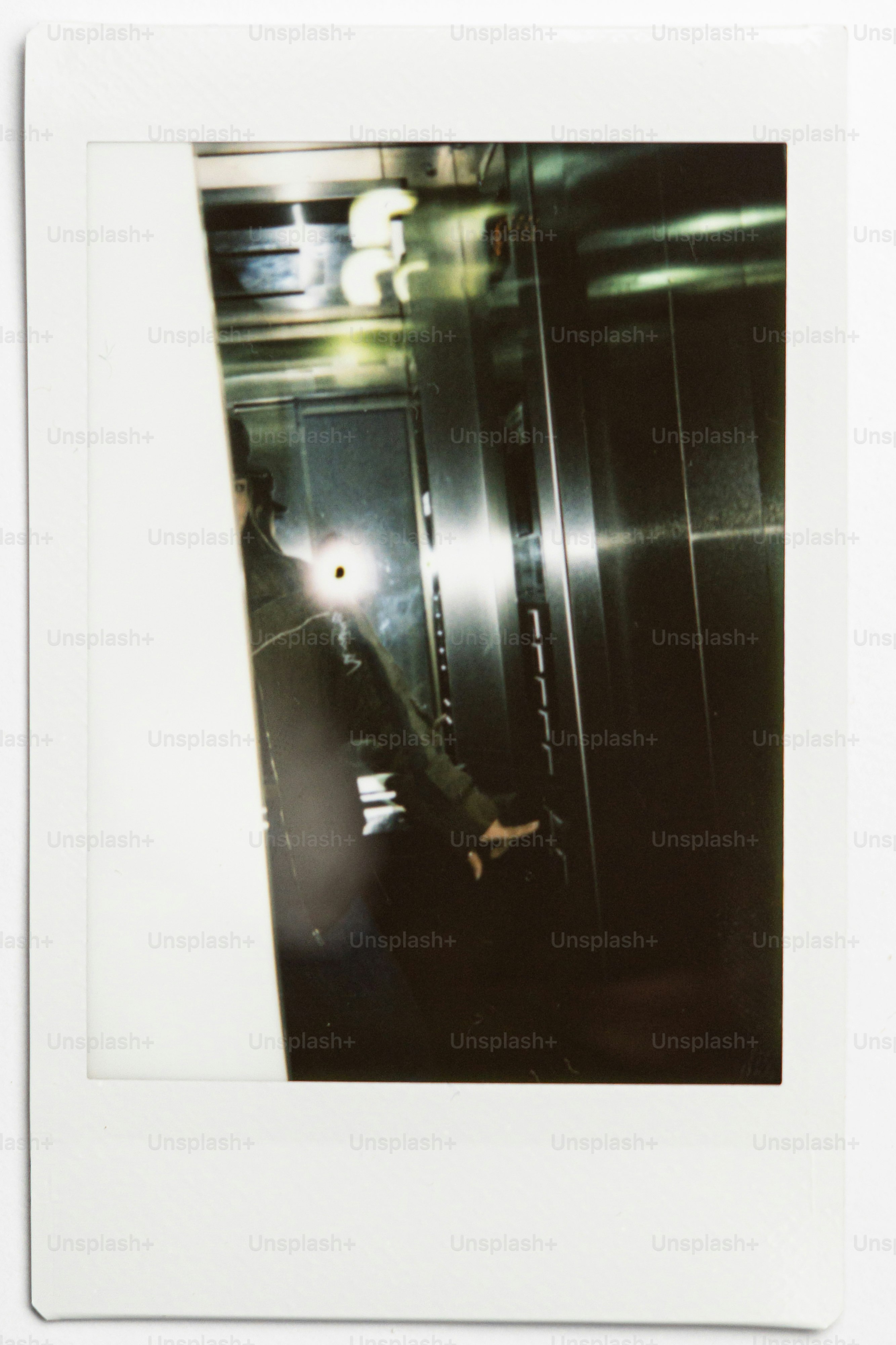 Person in a reflective elevator interior