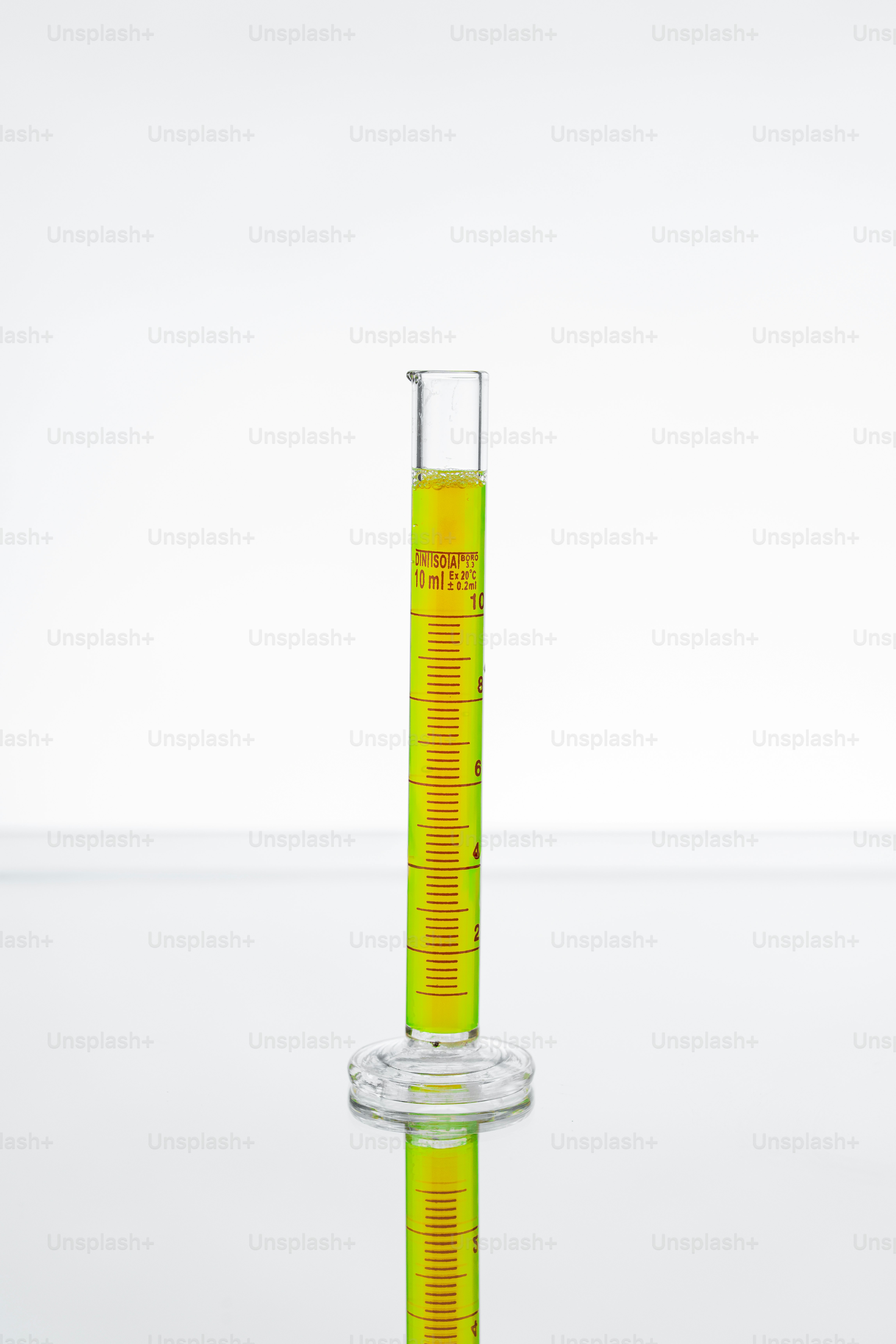 A graduated cylinder filled with yellow liquid.