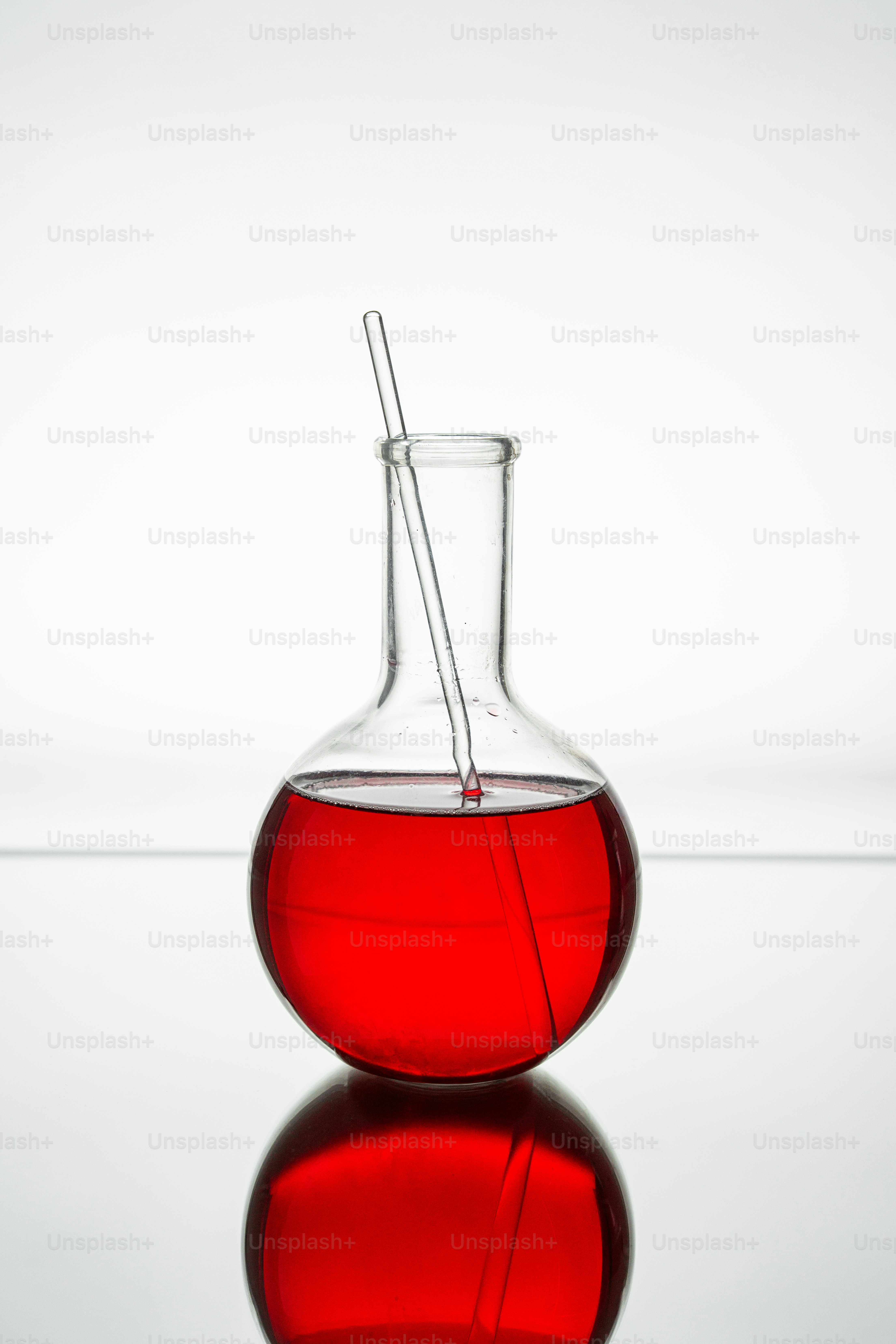 Round flask with red liquid and stirring rod