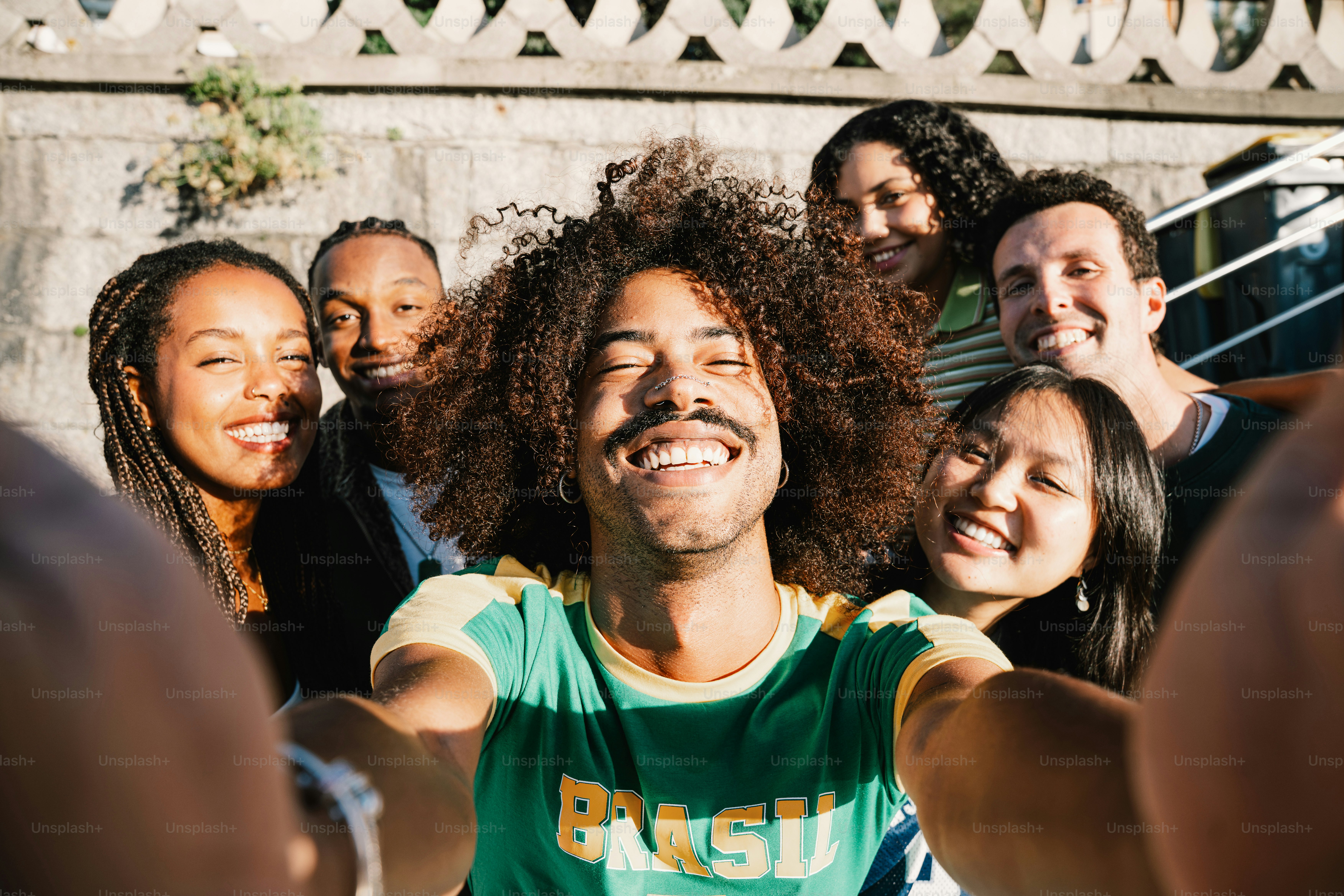 A group of diverse friends taking a selfie outdoors