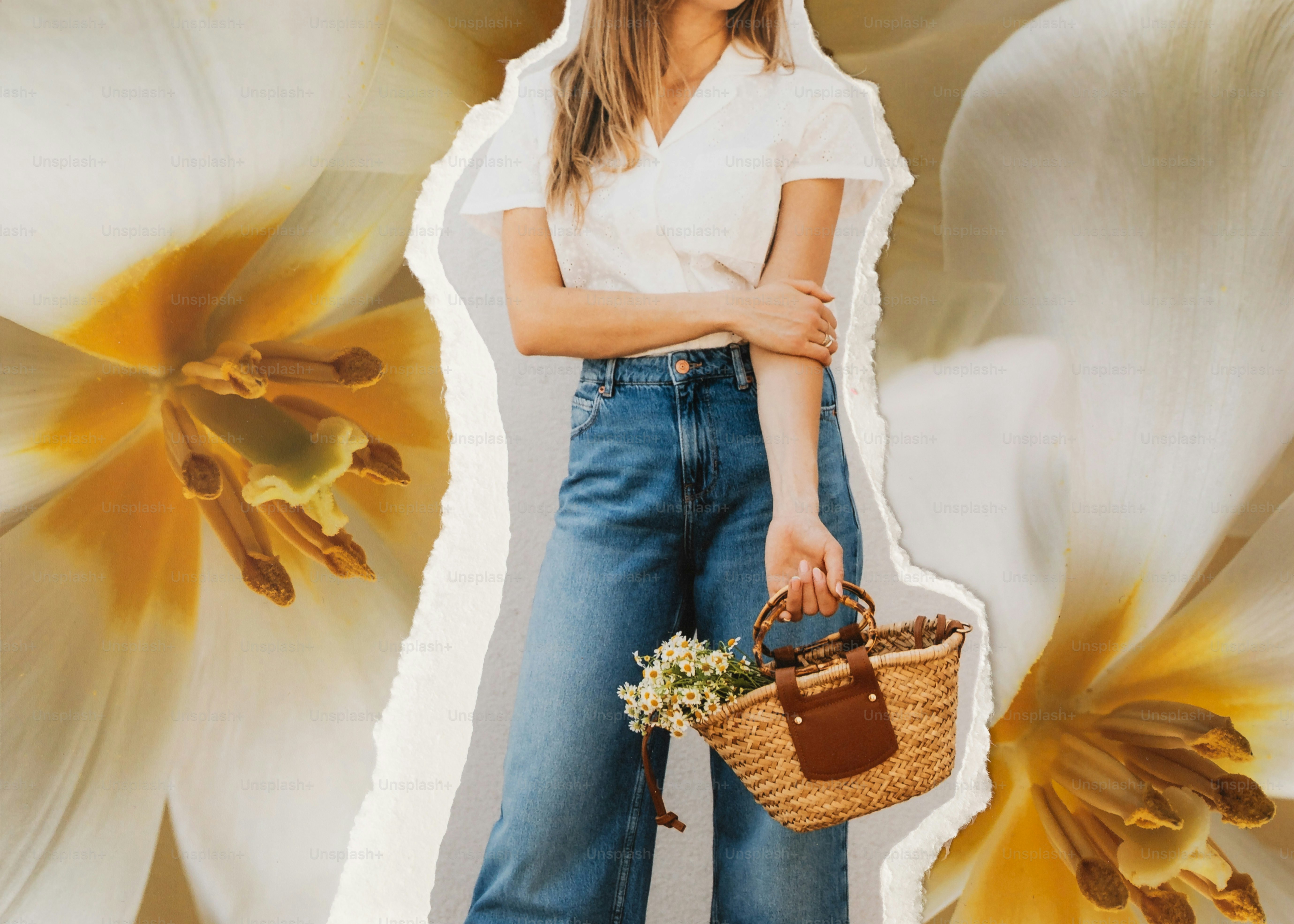 Woman in jeans holding a basket with flowers.