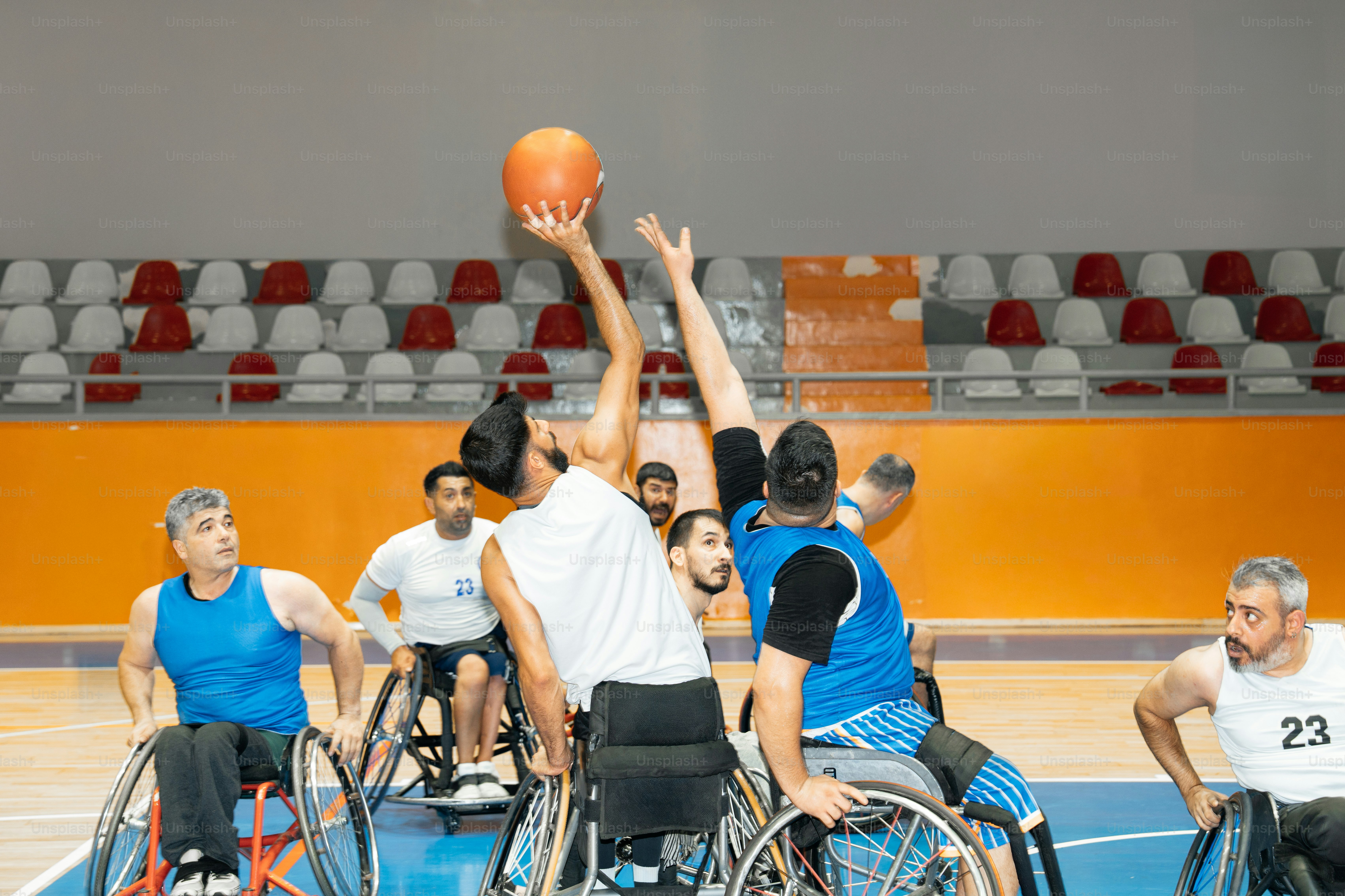 Wheelchair basketball players competing for the ball.