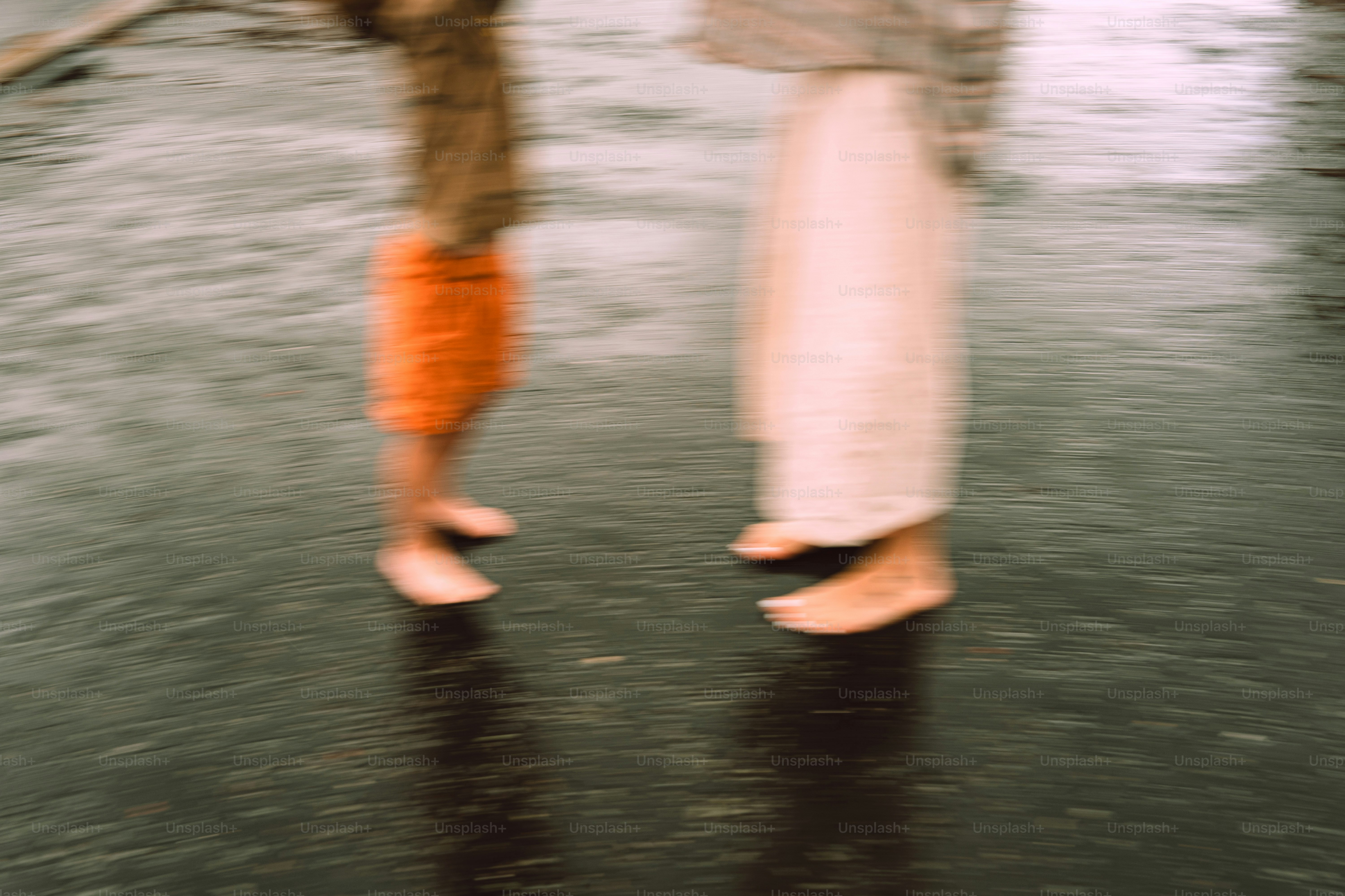 Two bare feet stand on wet ground